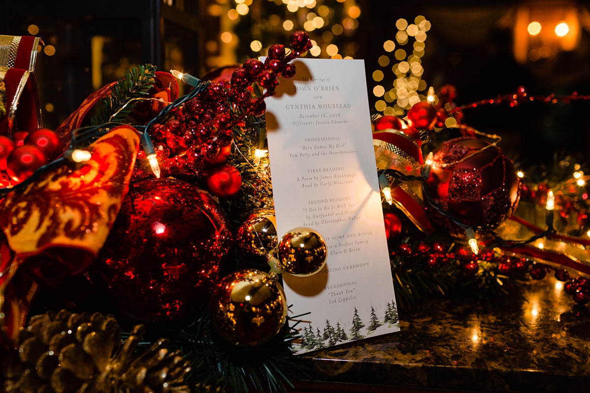 The Christmas and holiday decorations light up the couple's wedding program at their New Hampshire intimate wedding