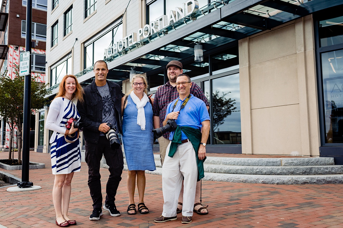 The five finalists and Nigel Barker pose for a photo in front of the AC Hotel Portland Maine at the grand opening event