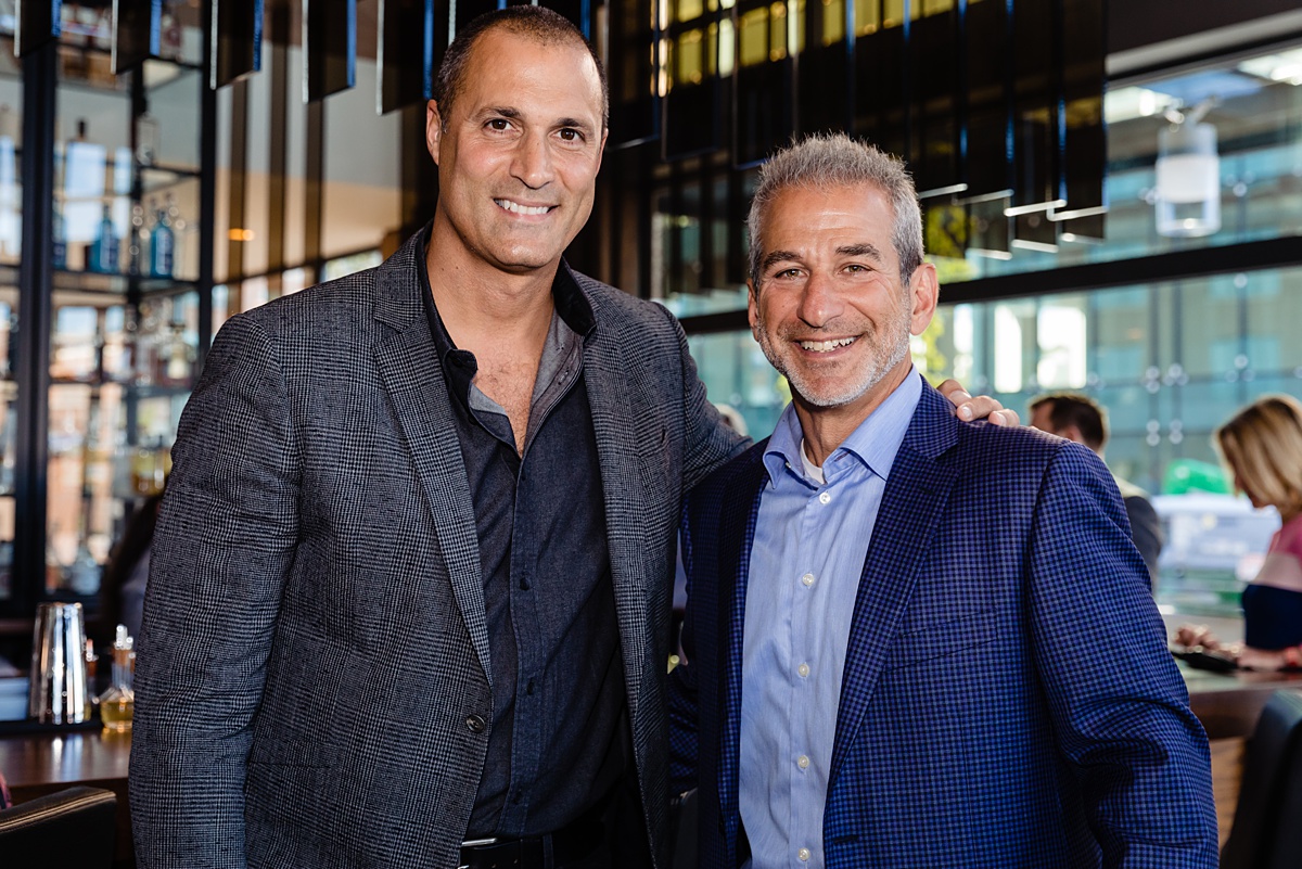 Nigel Barker poses with an AC Hotel Executive at the grand opening of the Portland Maine waterfront hotel