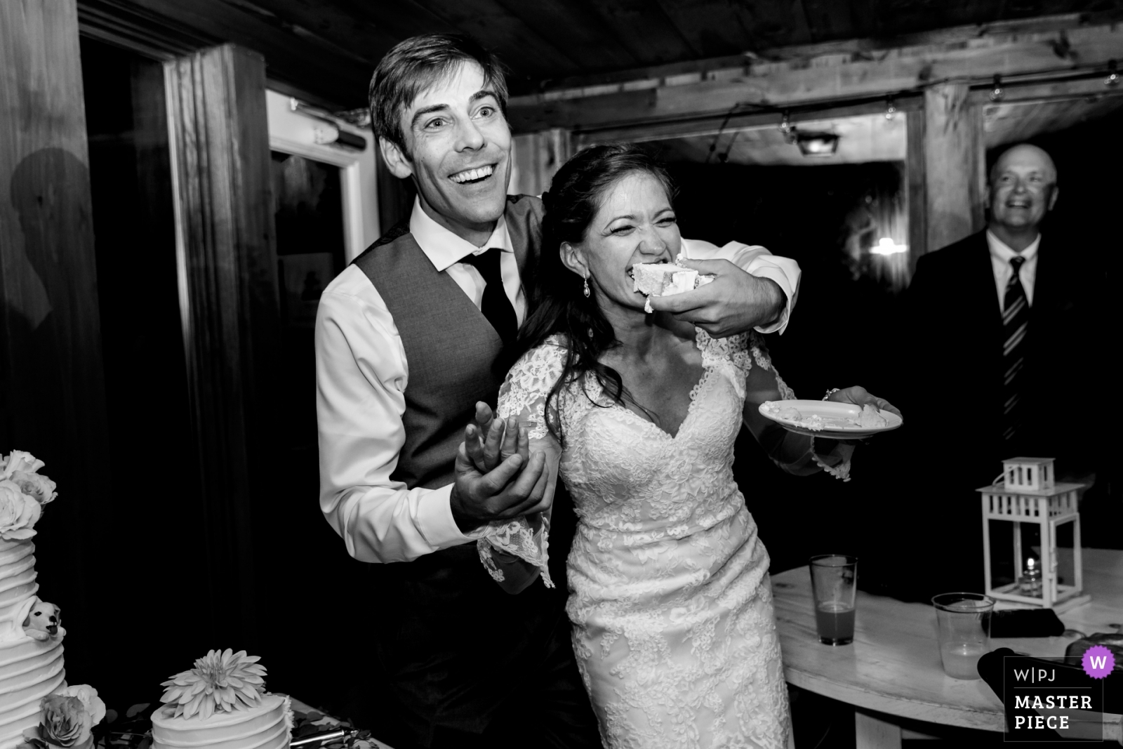 Linekin Bay Resort Boothbay Maine Wedding Photographer the bride and groom share a piece of cake in this award winning image