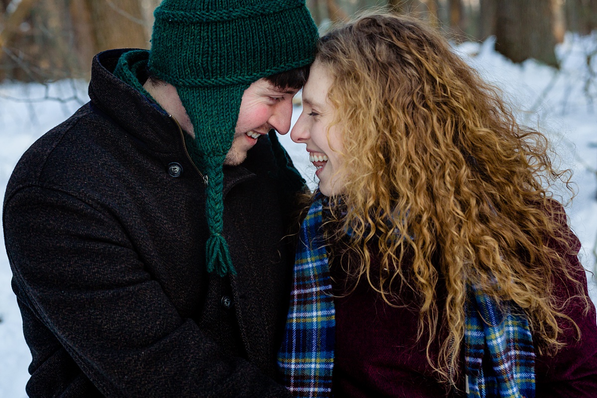 The couple gets in close for their snowy engagement session deep in the woods in Massachusetts