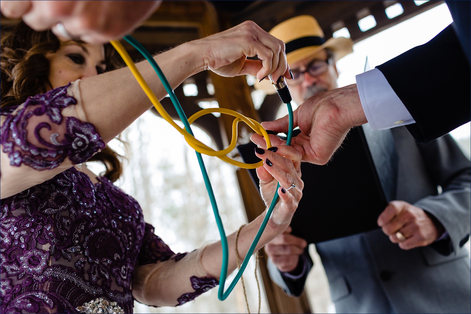 The bride and groom tie mic cables together for their ceremony outdoors in New Hampshire White Mountains