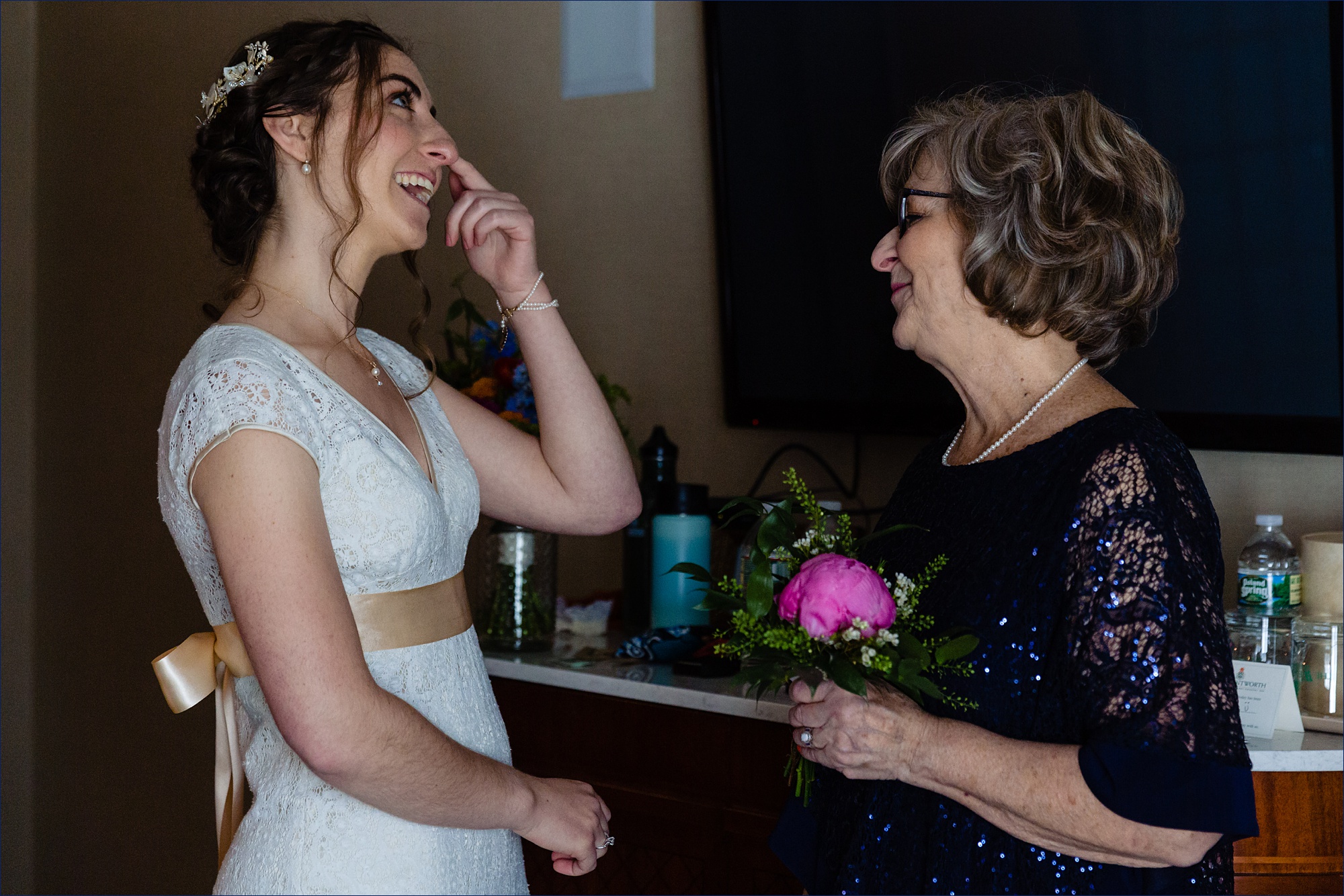 The bride tears up as her mom talks to her before her intimate NH wedding