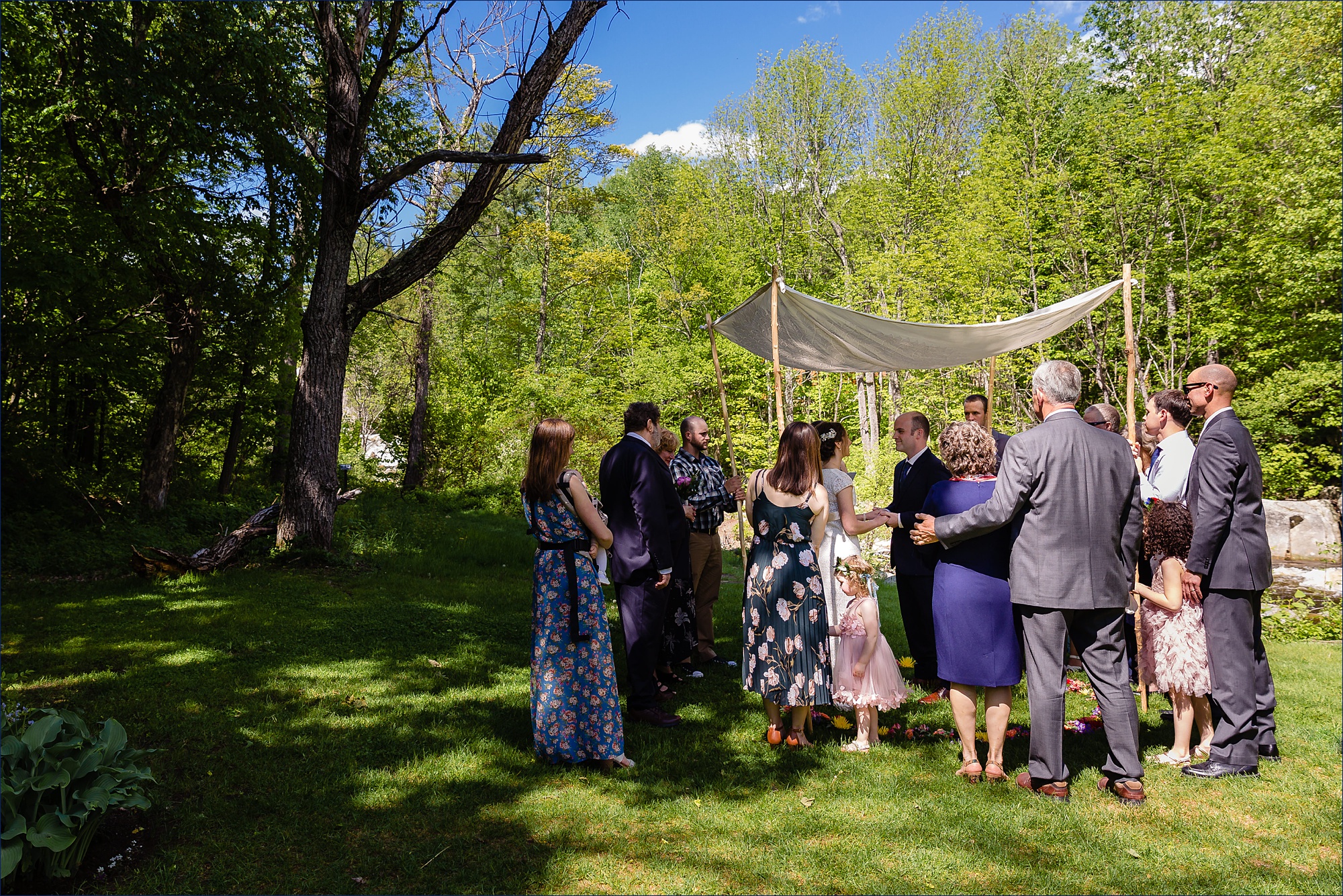 The family and the couple begin the intimate NH wedding ceremony under the chuppah in the White Mountains
