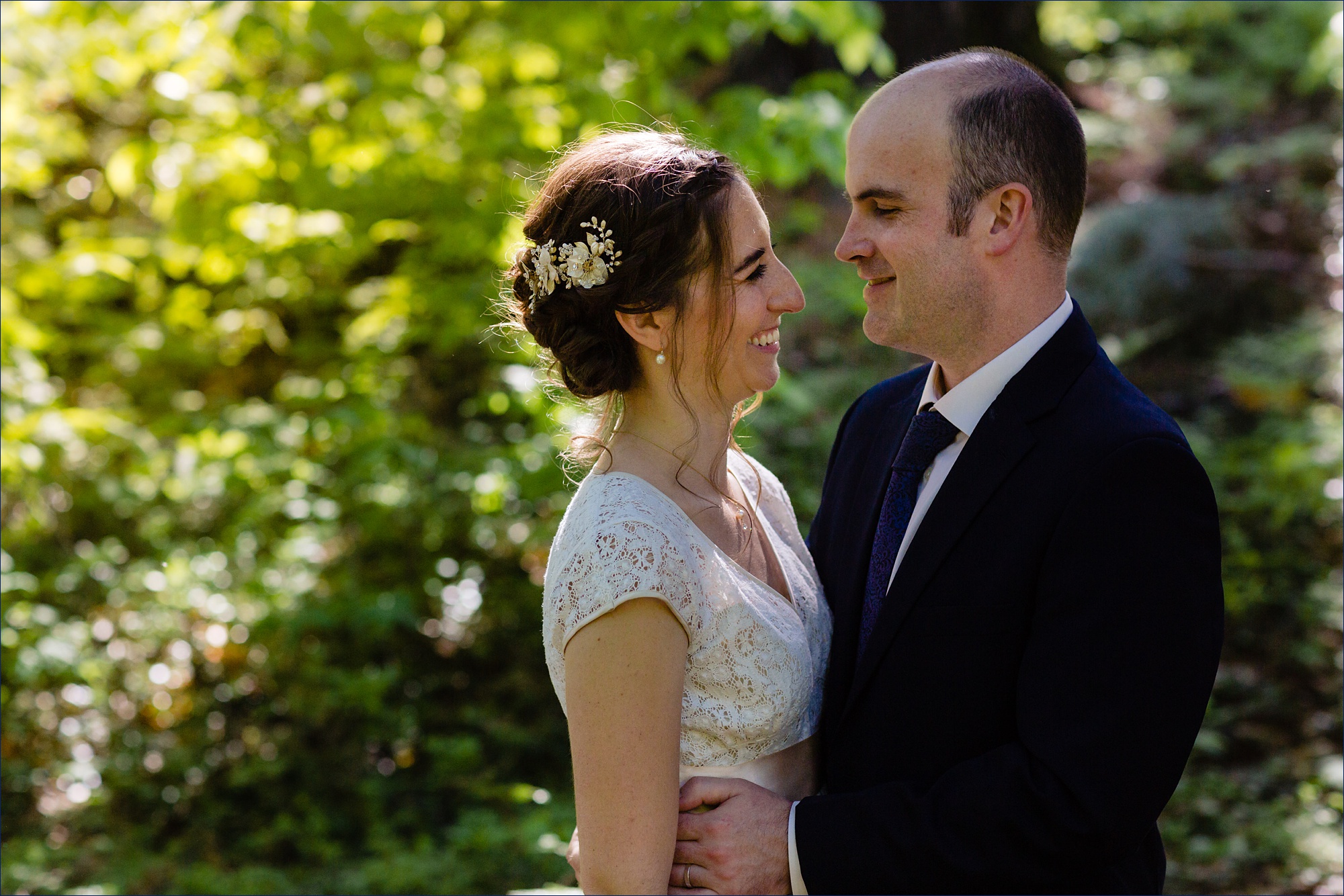 The newlyweds laugh in one other's arms after their White Mountain wedding in NH