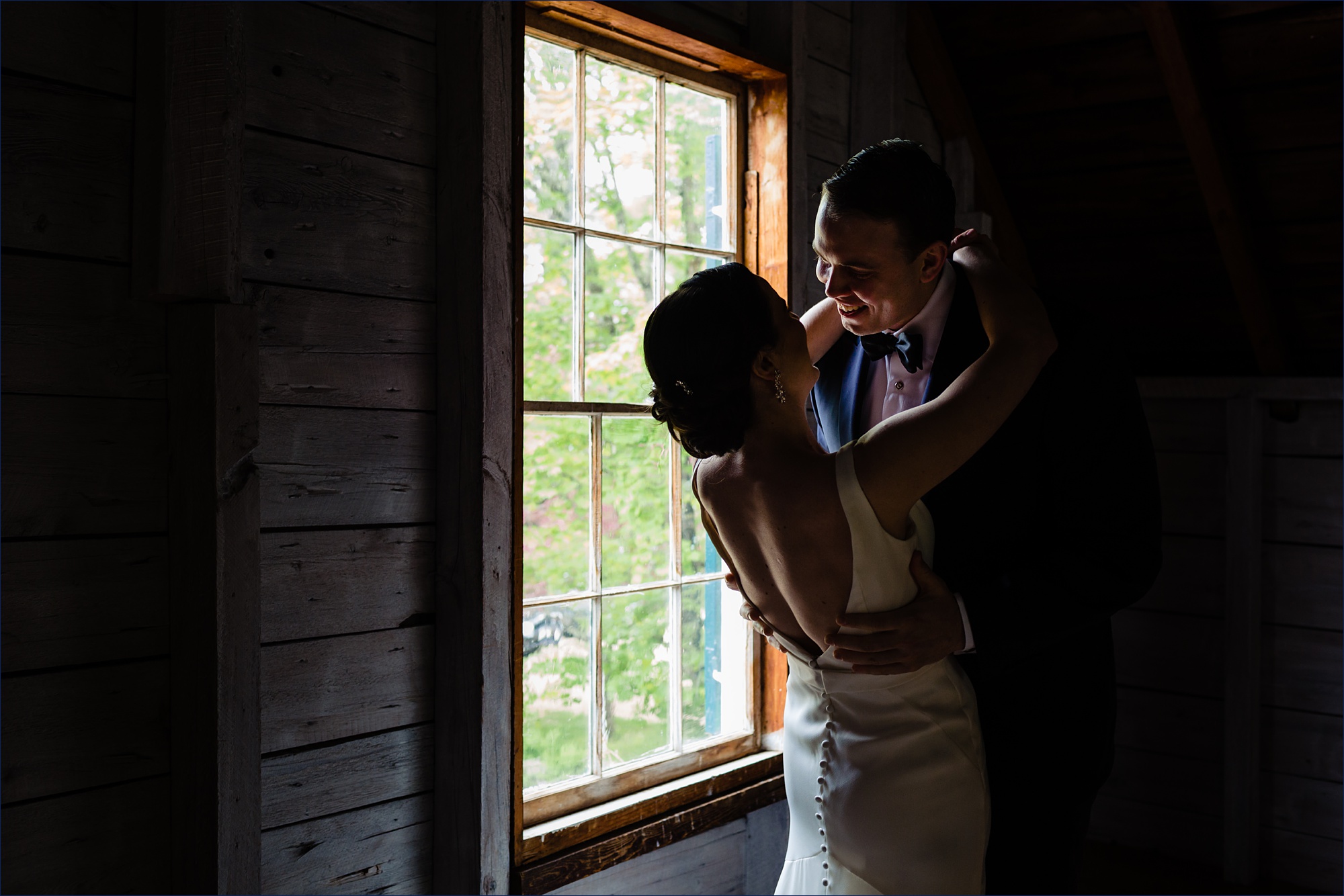 The bride and groom kiss after their first look at Hardy Farm in Maine