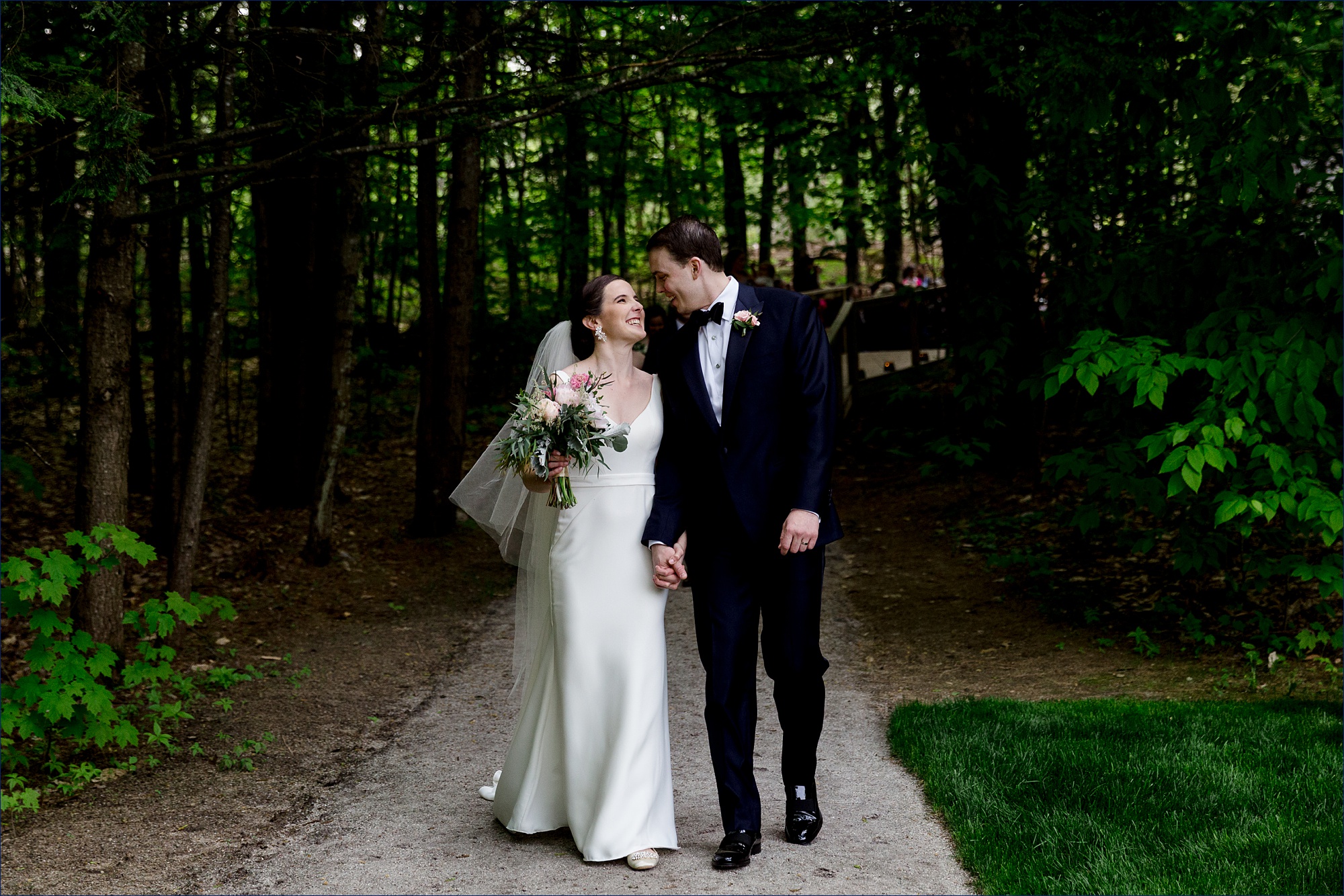 Hardy Farm Wedding where the bride and groom exit the ceremony in the woods with giant smiles