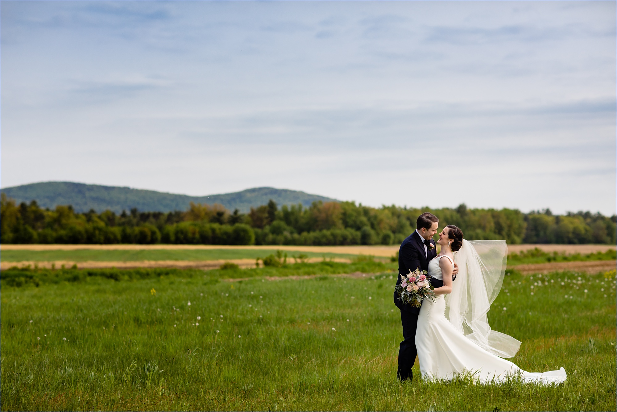 Hardy Farm wedding in Maine where the couple seals the deal with a kiss in front of the White Mountains