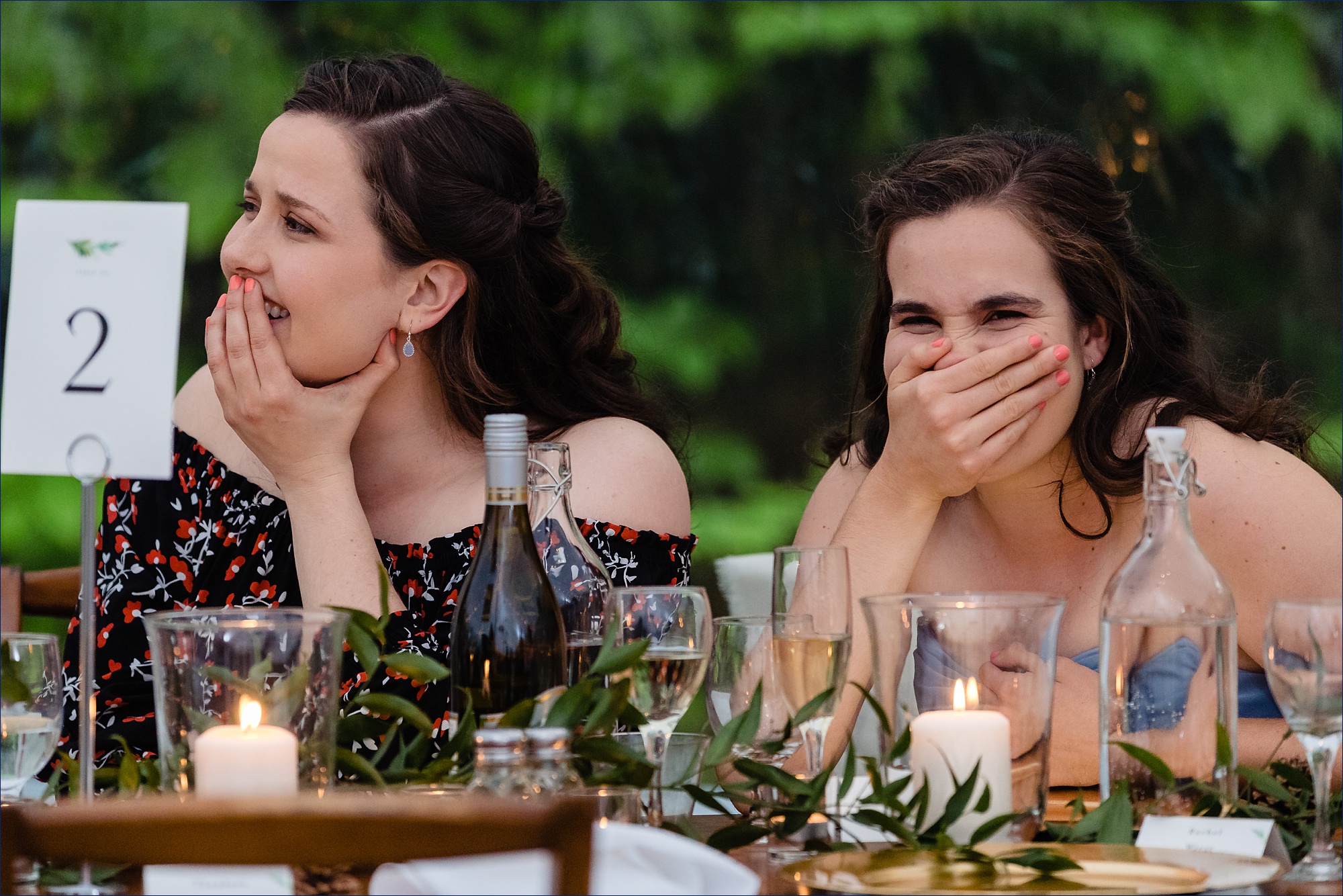 Guests laugh at the toasts at the outdoor Maine wedding reception