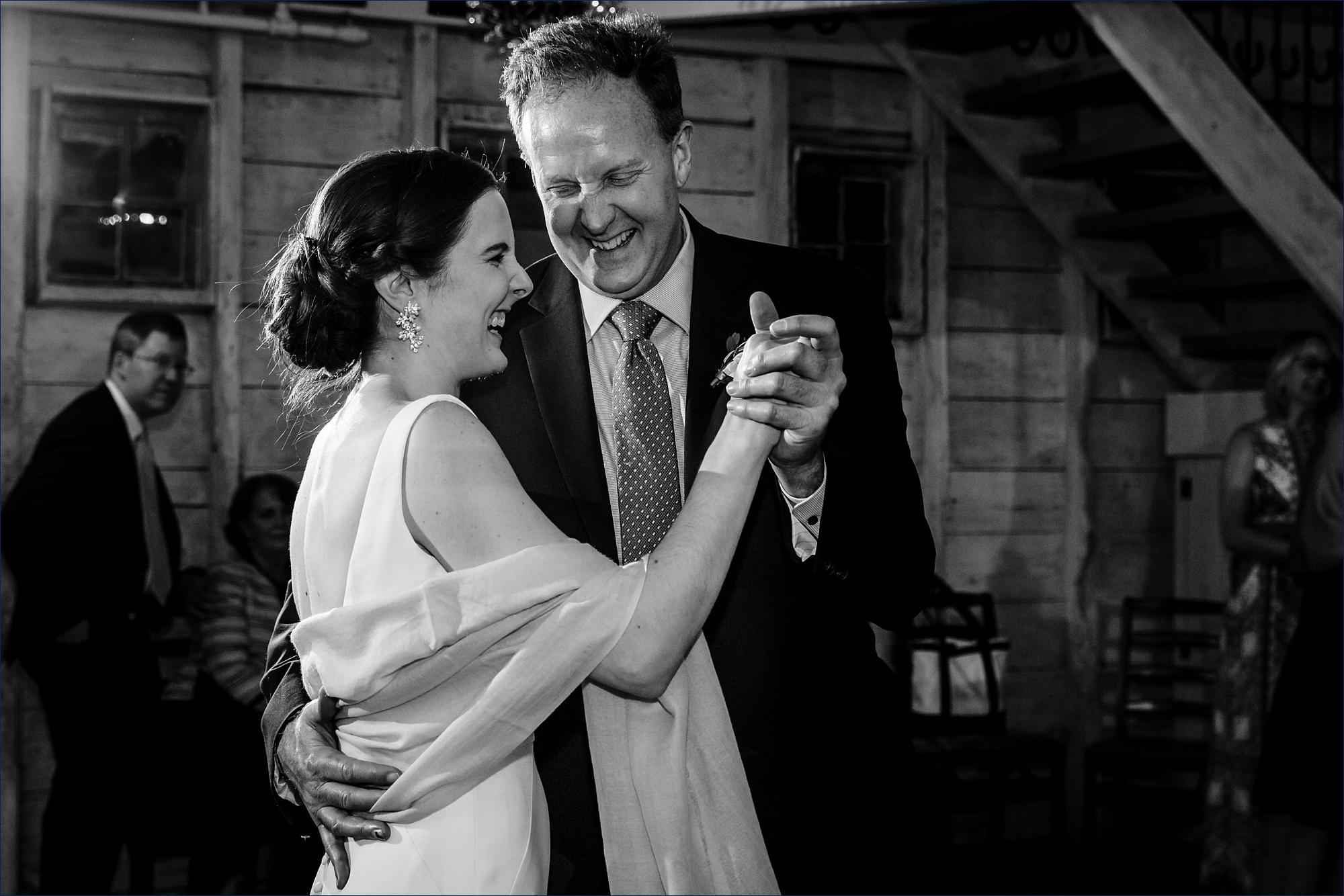 The bride and her father dance together in the barn at Hardy Farm and enjoy a laugh