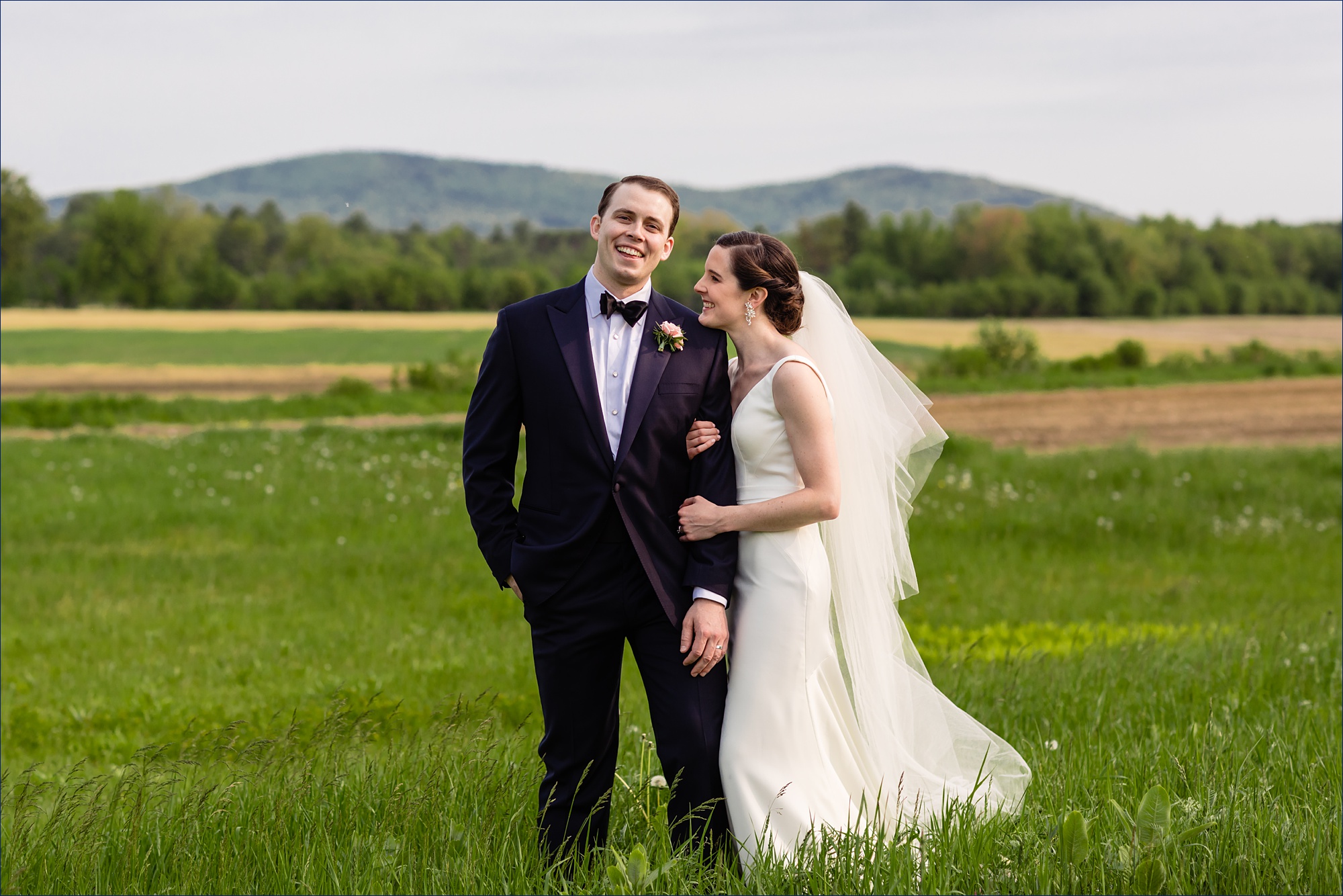 Hardy Farm wedding the bride and groom laugh together out in front of the White Mountains