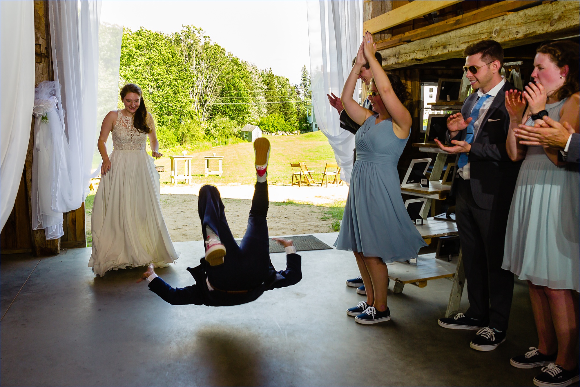 The groom is captured mid back breaking into the wedding reception 