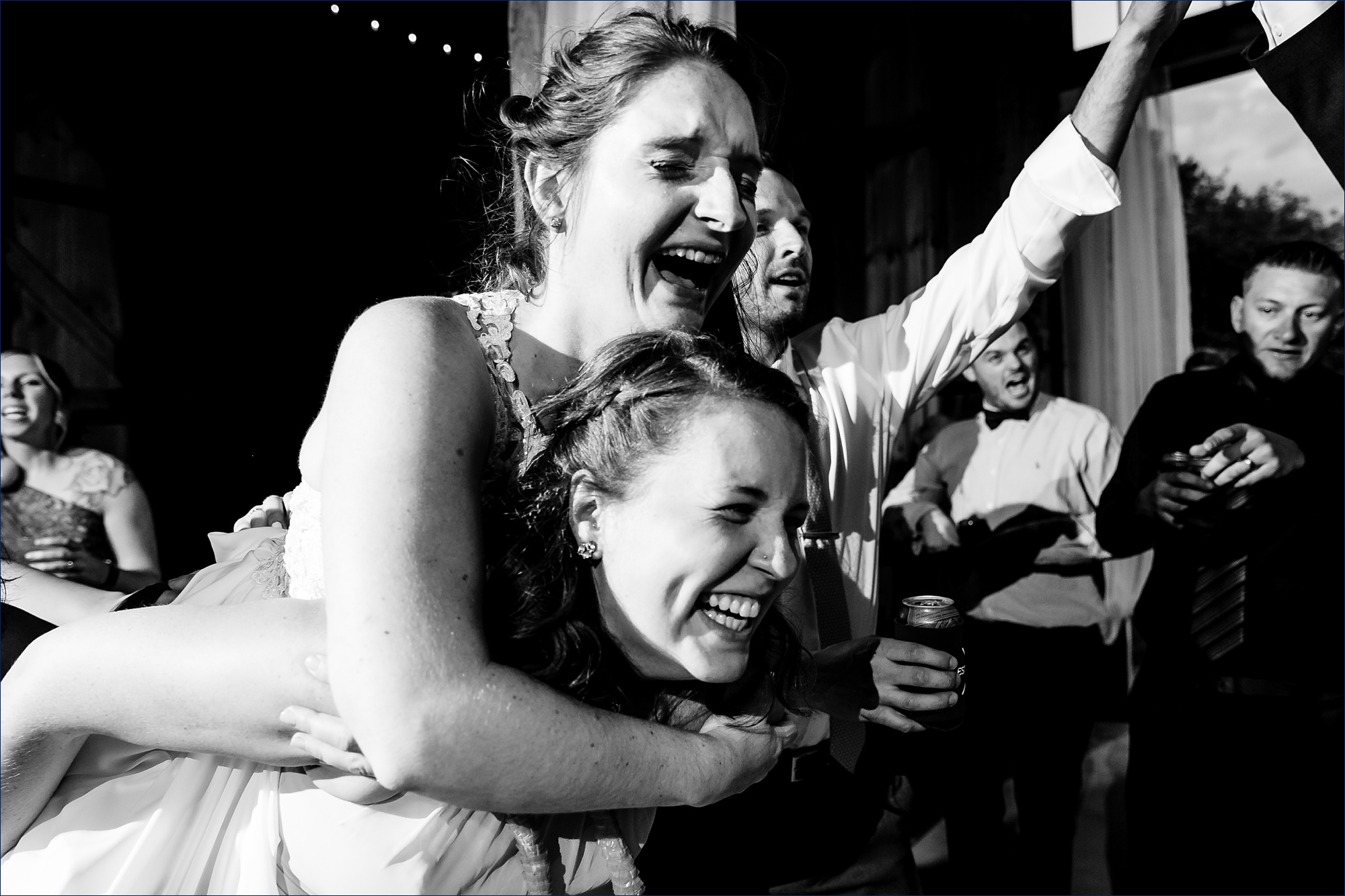 The bride plays chicken on her best friend's back at the wedding reception at Kitz Farm in NH