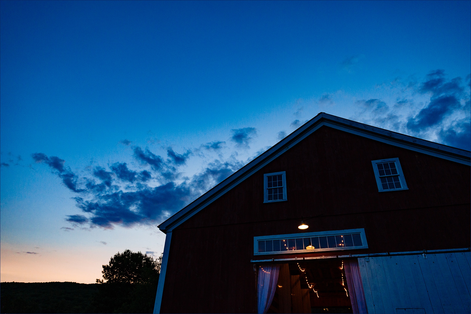 The barn at Kitz Farm in Strafford New Hampshire against a blue sky