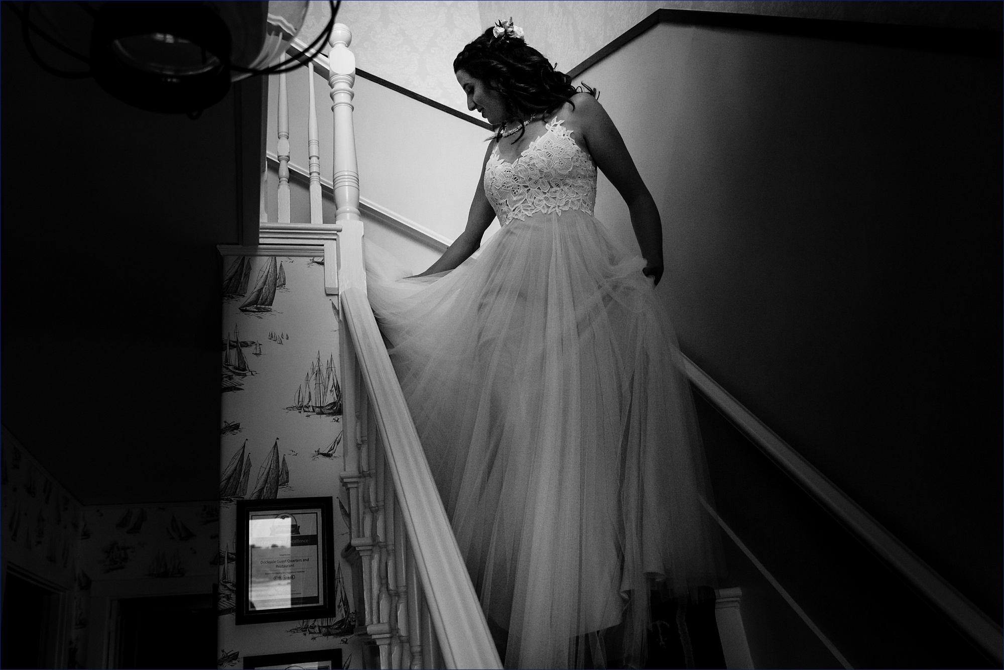 The bride comes down the stairs to head to the first look in Maine