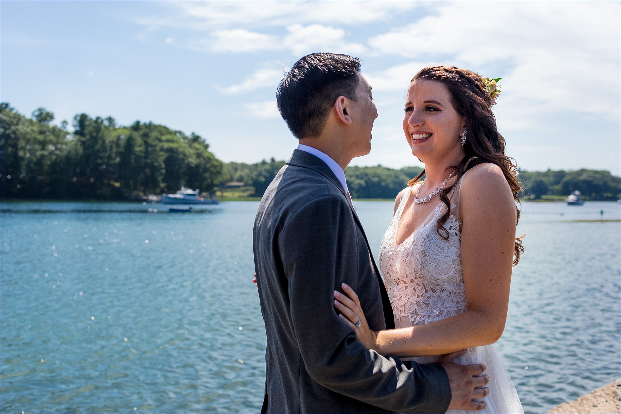 The bride and groom laugh while out on the Wiggly Bridge in York Maine for their wedding day