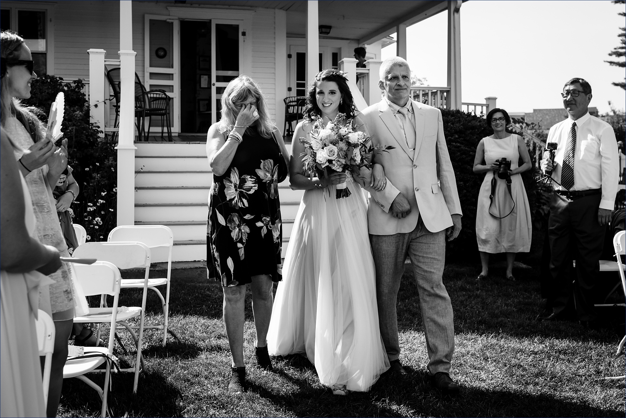 The bride and her teary mom and dad walk her down the aisle at her southern Maine wedding