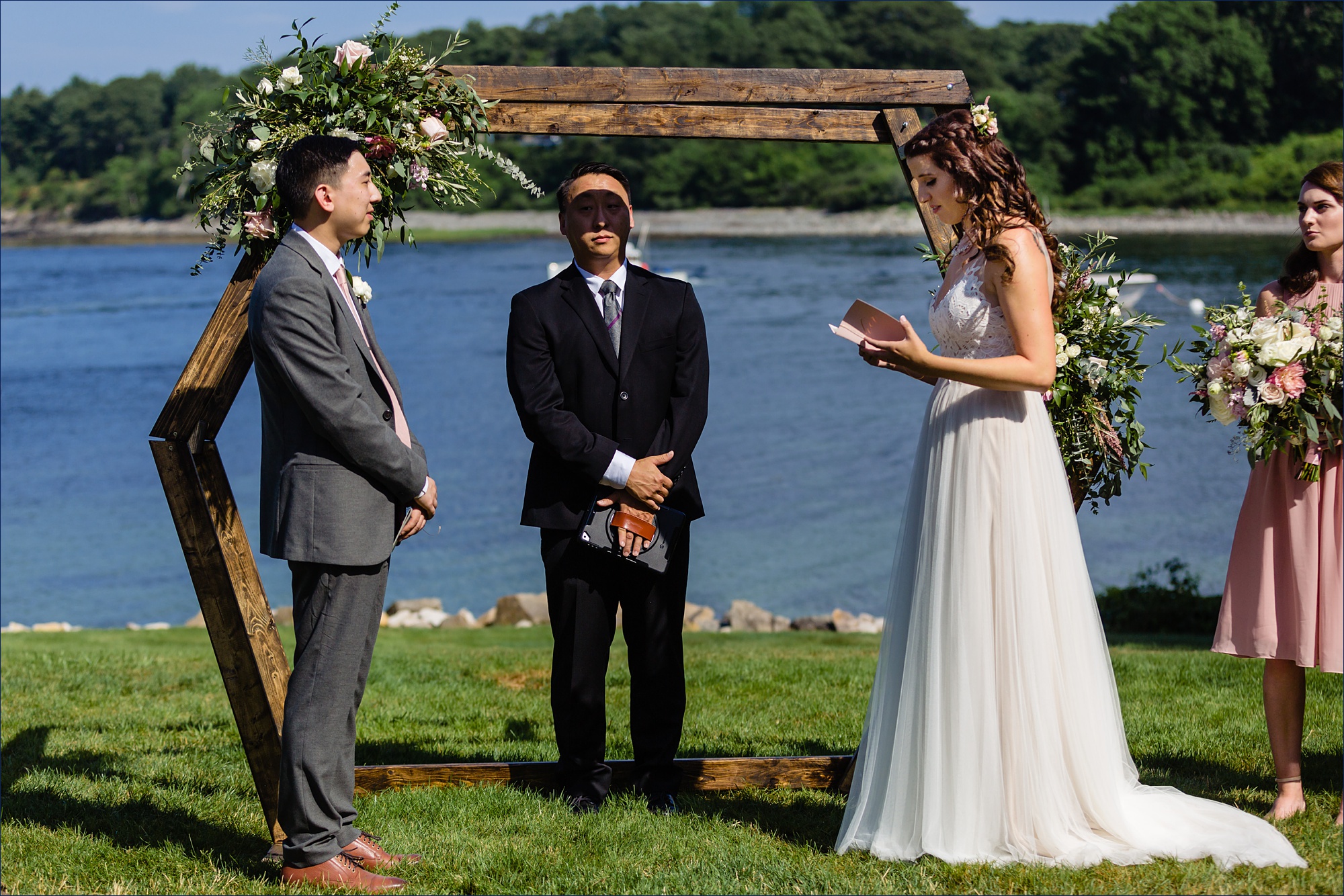 The bride and groom read their vows to one another at their York Maine Wedding