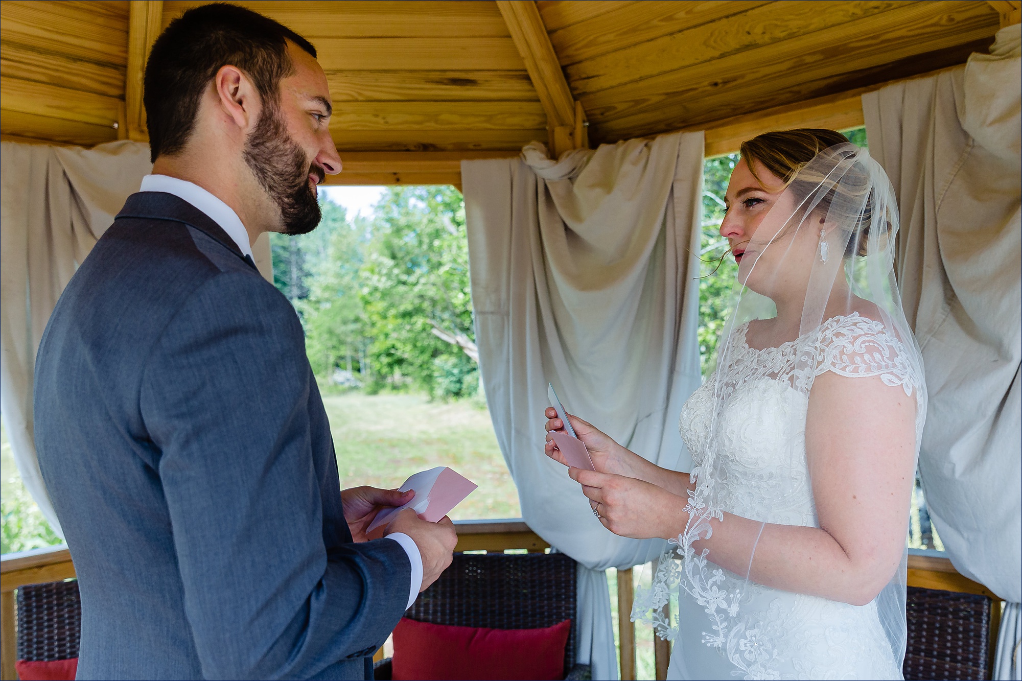 The bride and groom tear up after sharing cards with one another after the first look