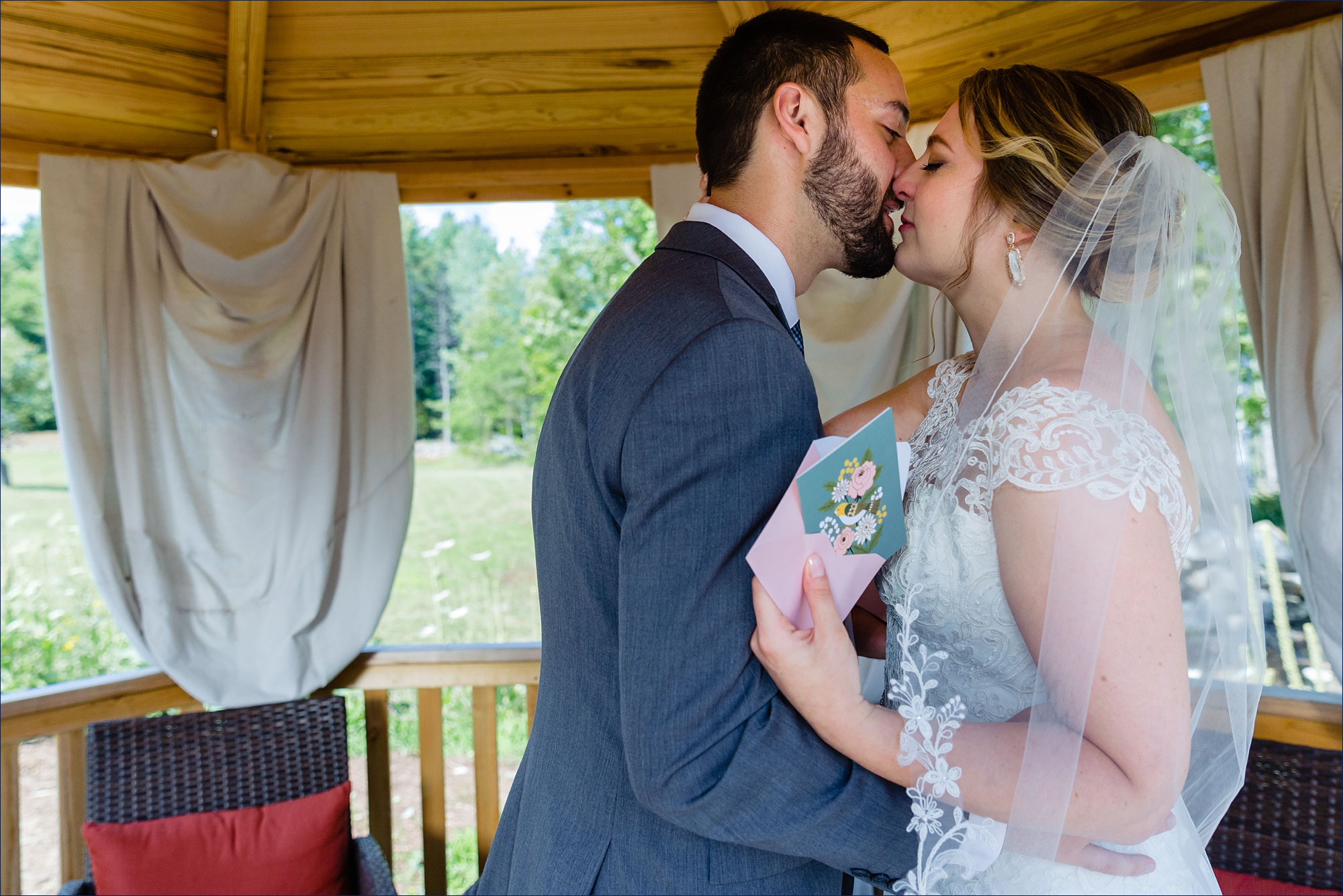 The bride and groom share a kiss after their first look in the gazebo in NH