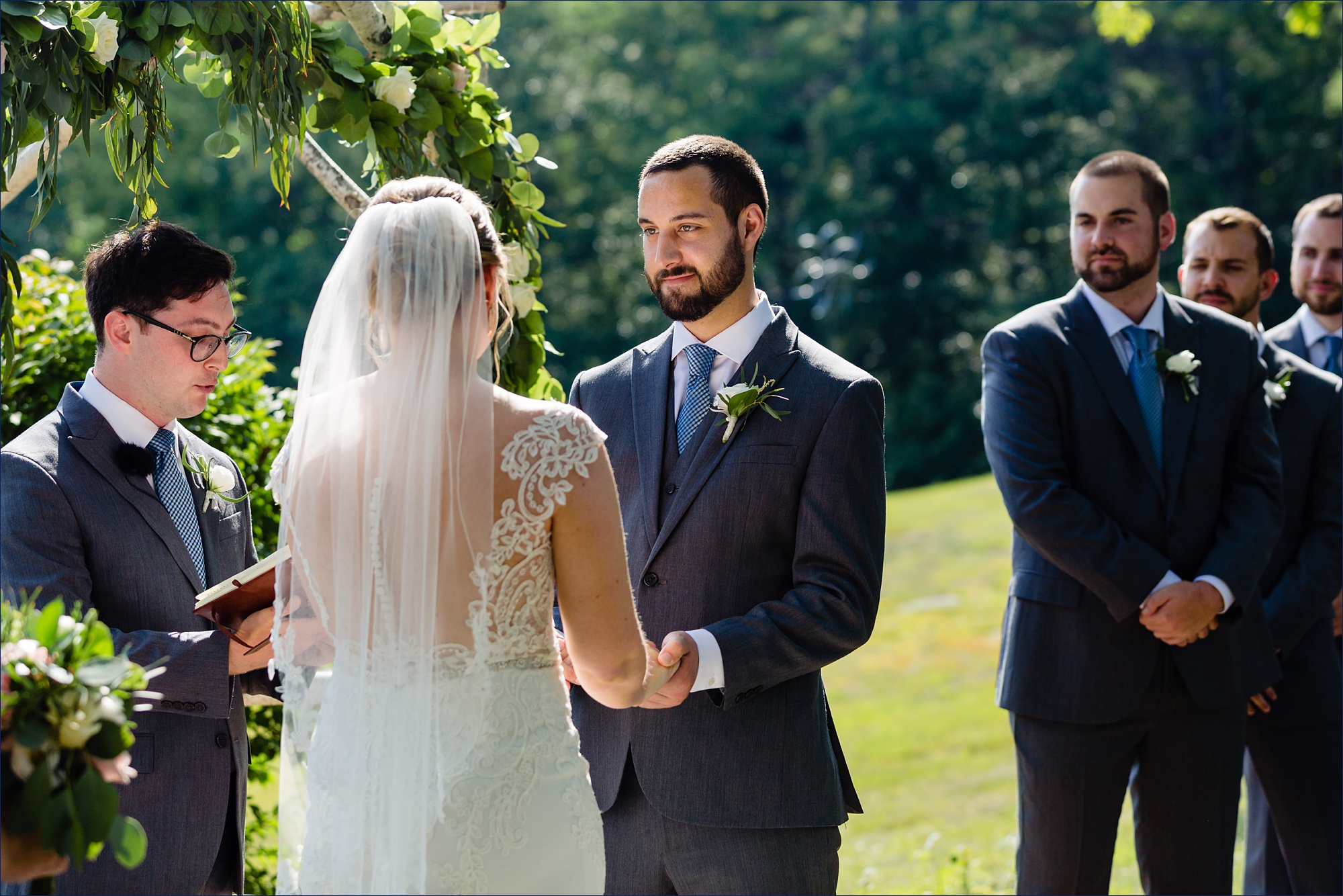 The groom looks lovingly at the bride while at their New Hampshire wedding