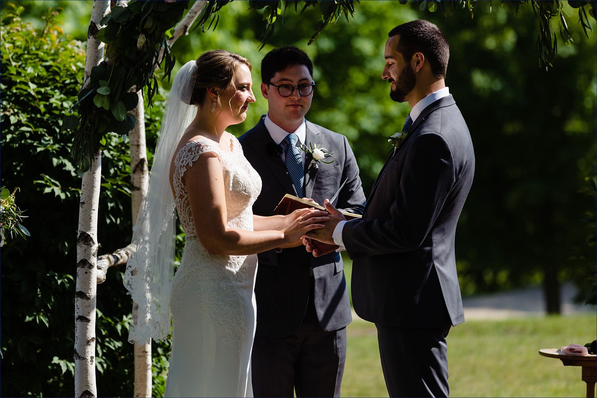 The bride and groom exchange rings during their outdoor ceremony at The Preserve at Chocorua in NH