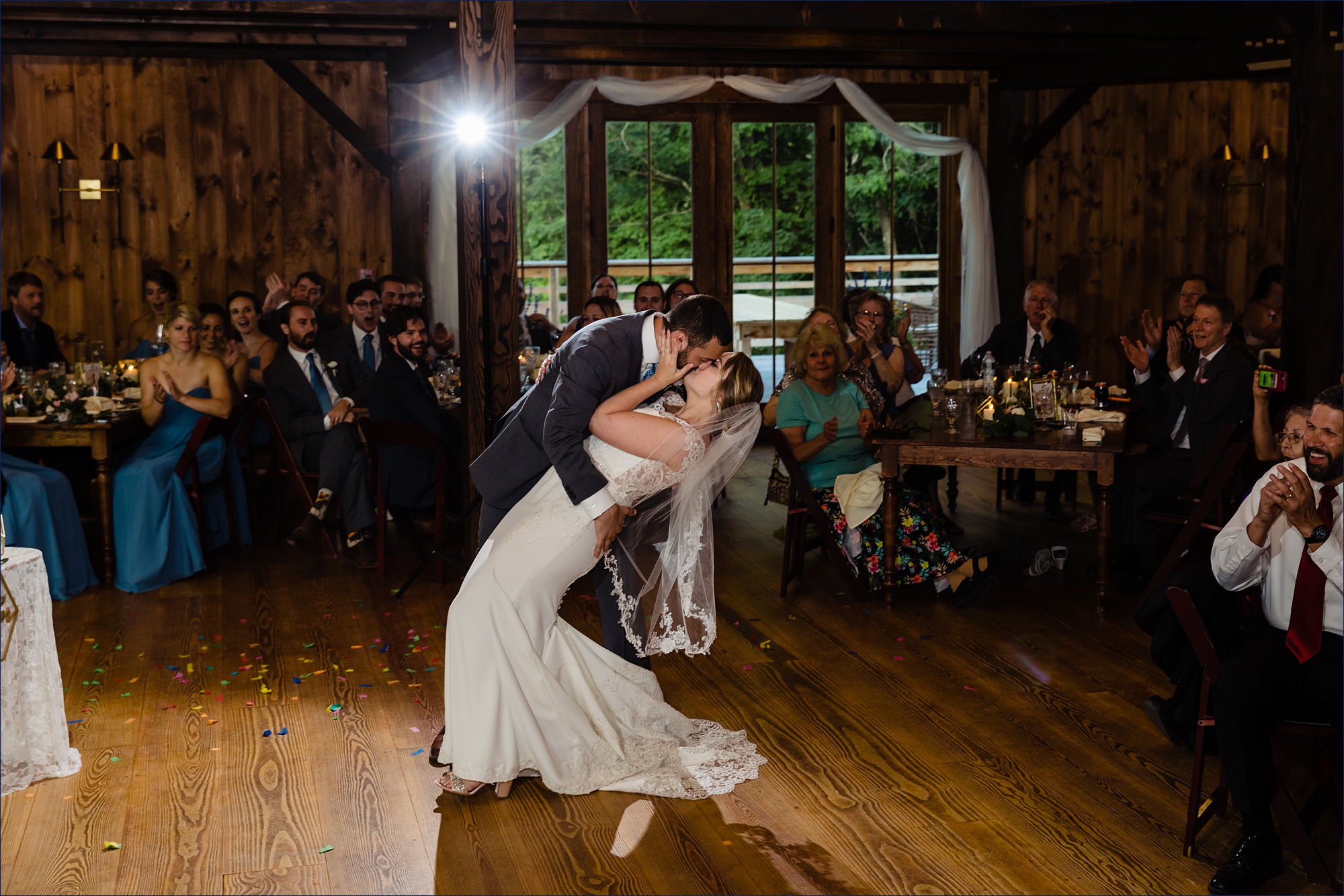 The groom expertly dips the bride in the barn at their Preserve at Chocorua wedding reception