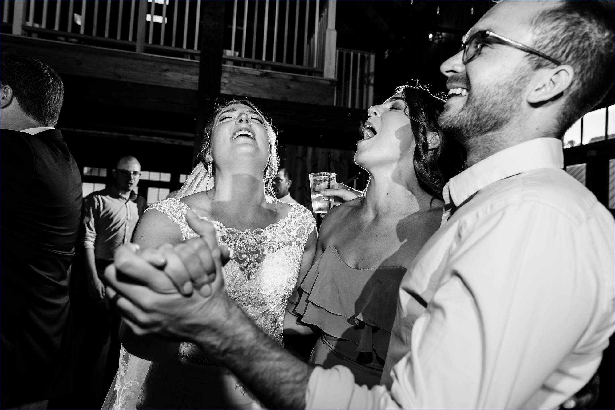 The bride and groom dance with guests inside the barn at The Preserve at Chocorua NH wedding
