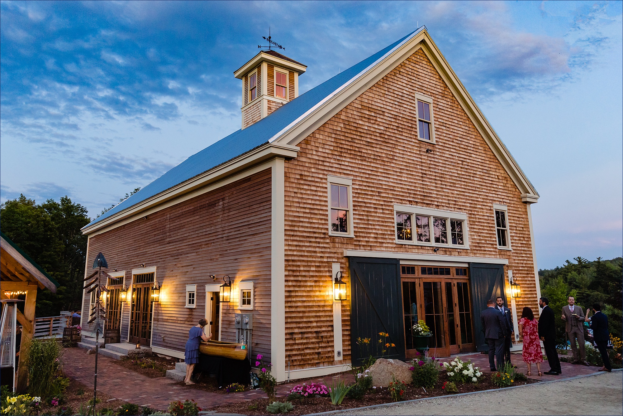 The barn at the Preserve at Chocorua NH stands tall in the sunset light at the end of a wedding day