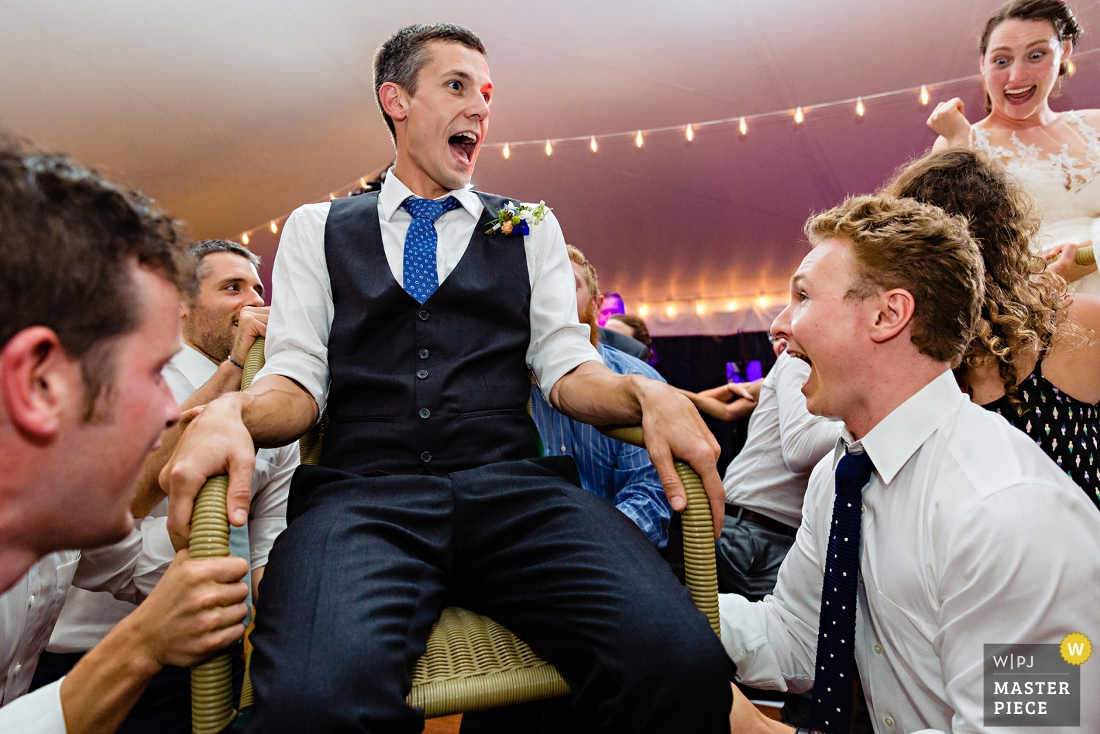 Ellsworth Maine Wedding Photographer with an award winning image of the hora dance at the tented reception up near Bar Harbor Maine
