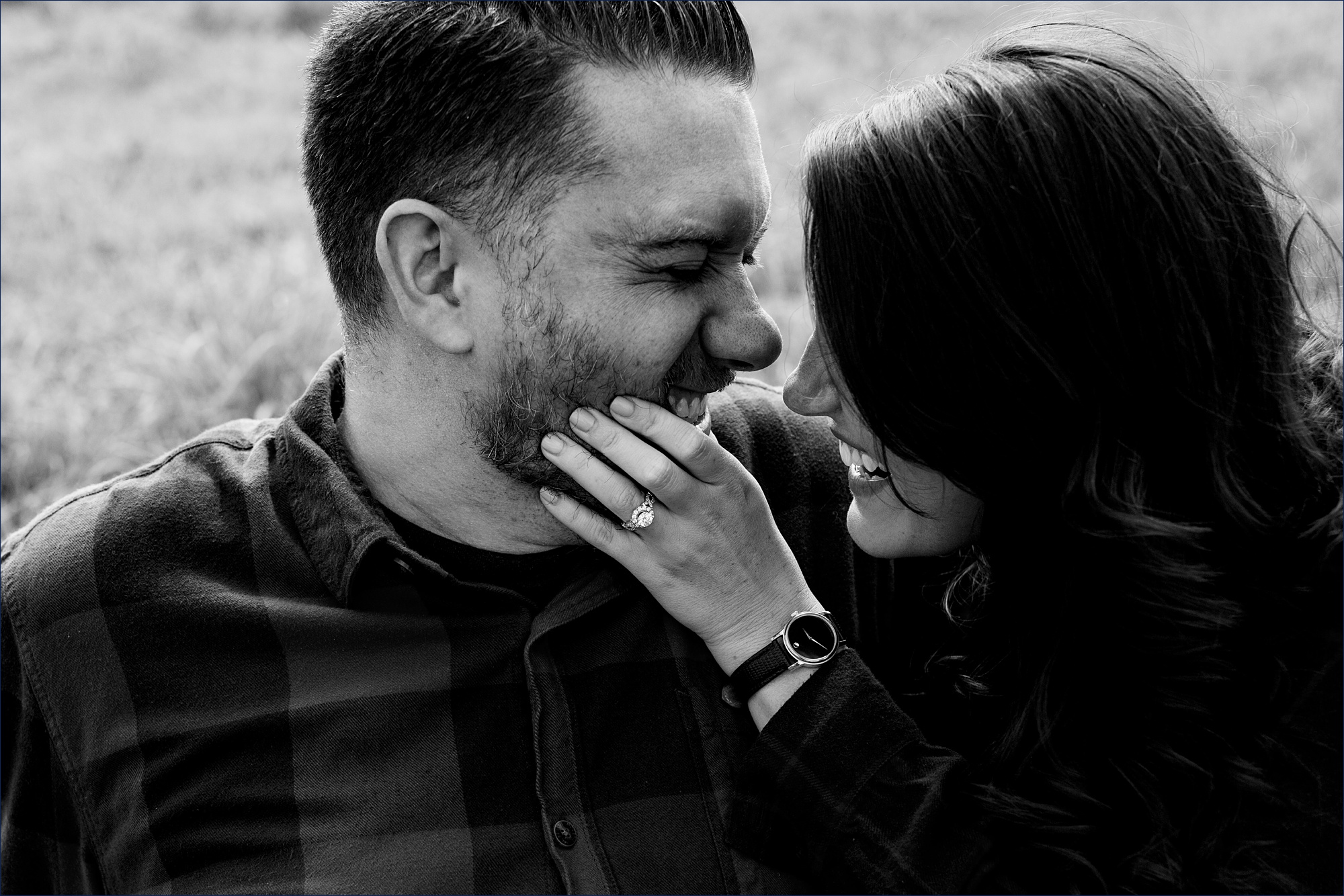 She squeezes his face tight and laughs with him for their engagement photos