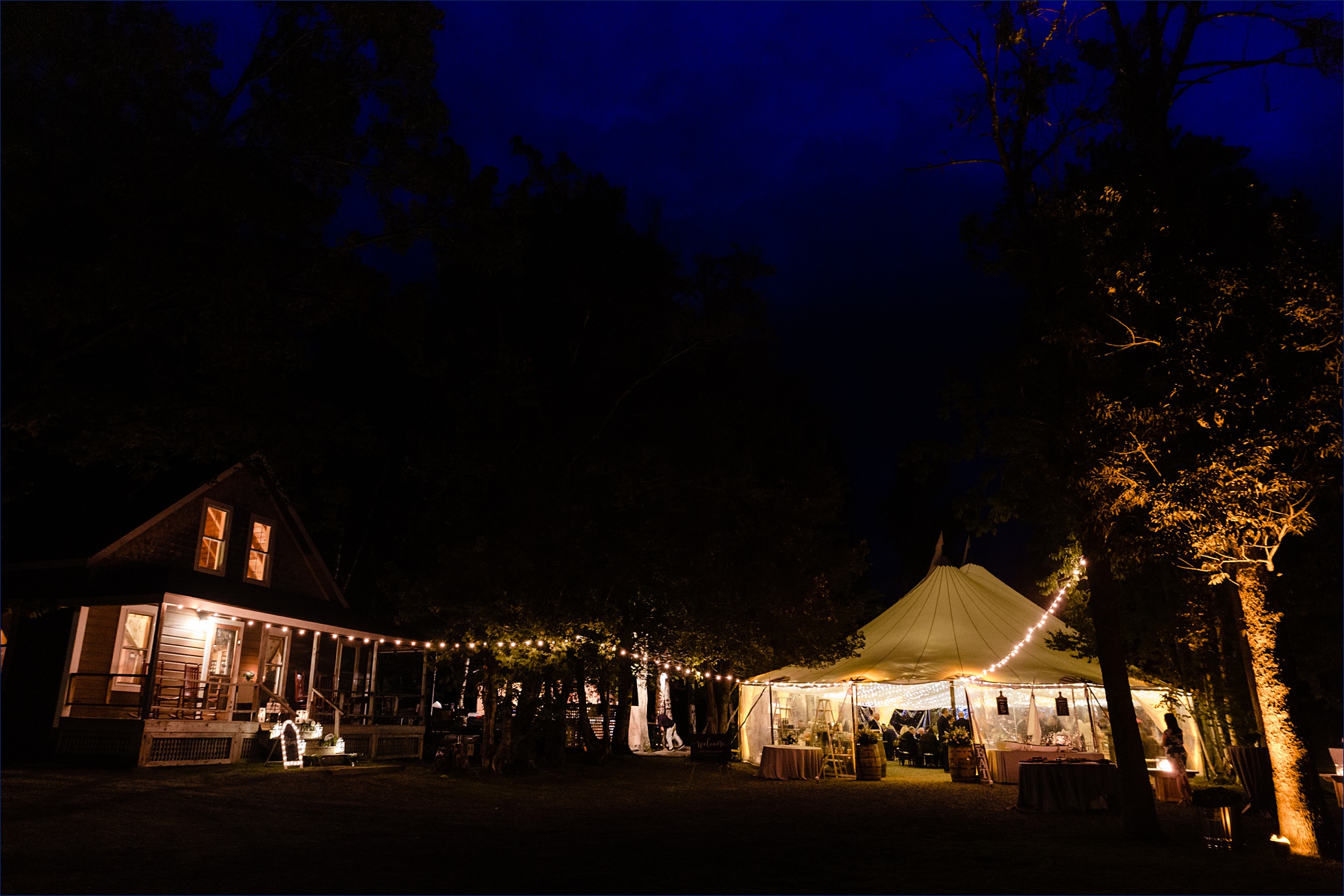 The tented reception under a deep blue Maine sky at Bald Mountain Camps