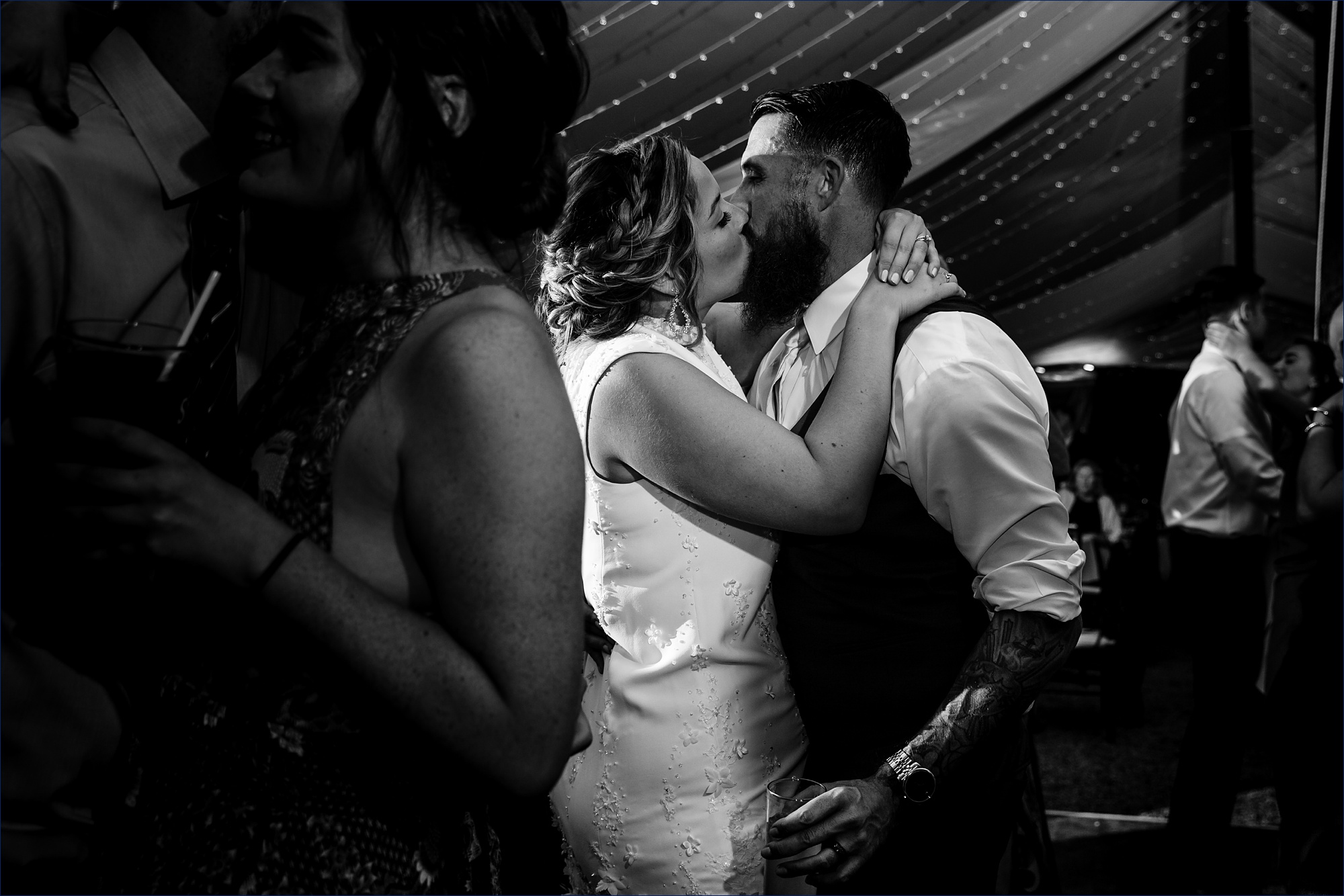 Bride and groom sneak a kiss on the dance floor