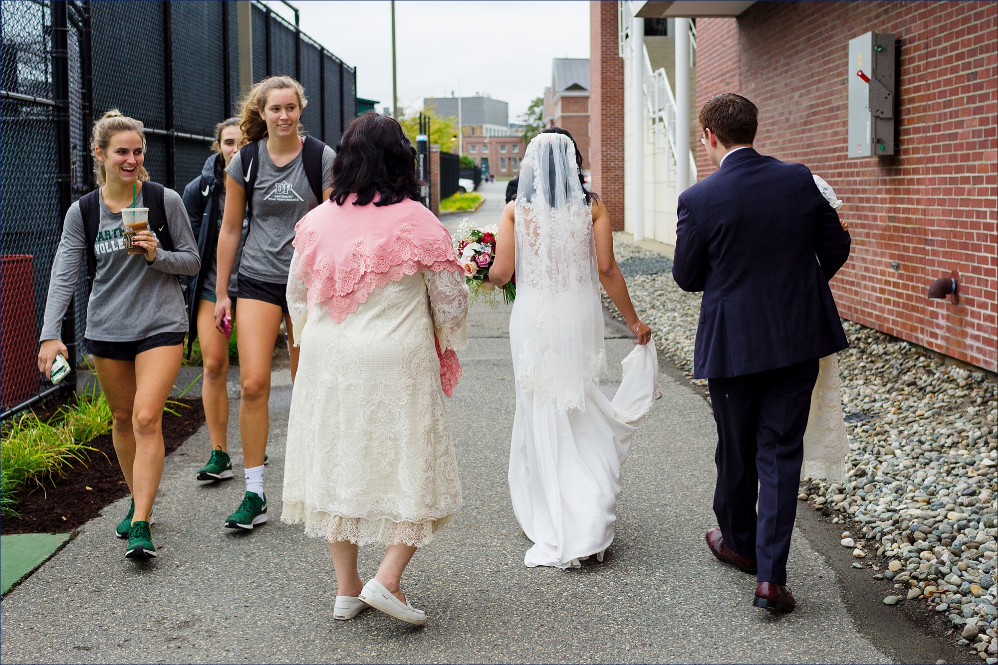 The family gets smiles from Dartmouth students as they head to the wedding ceremony