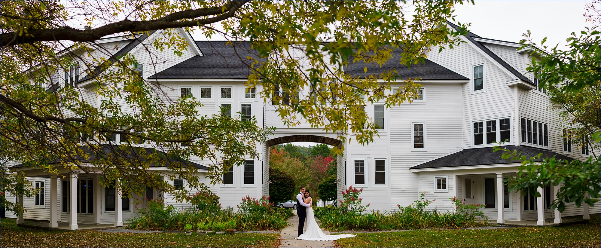 A panorama of the newlyweds outside of their home after their NH elopement in the fall