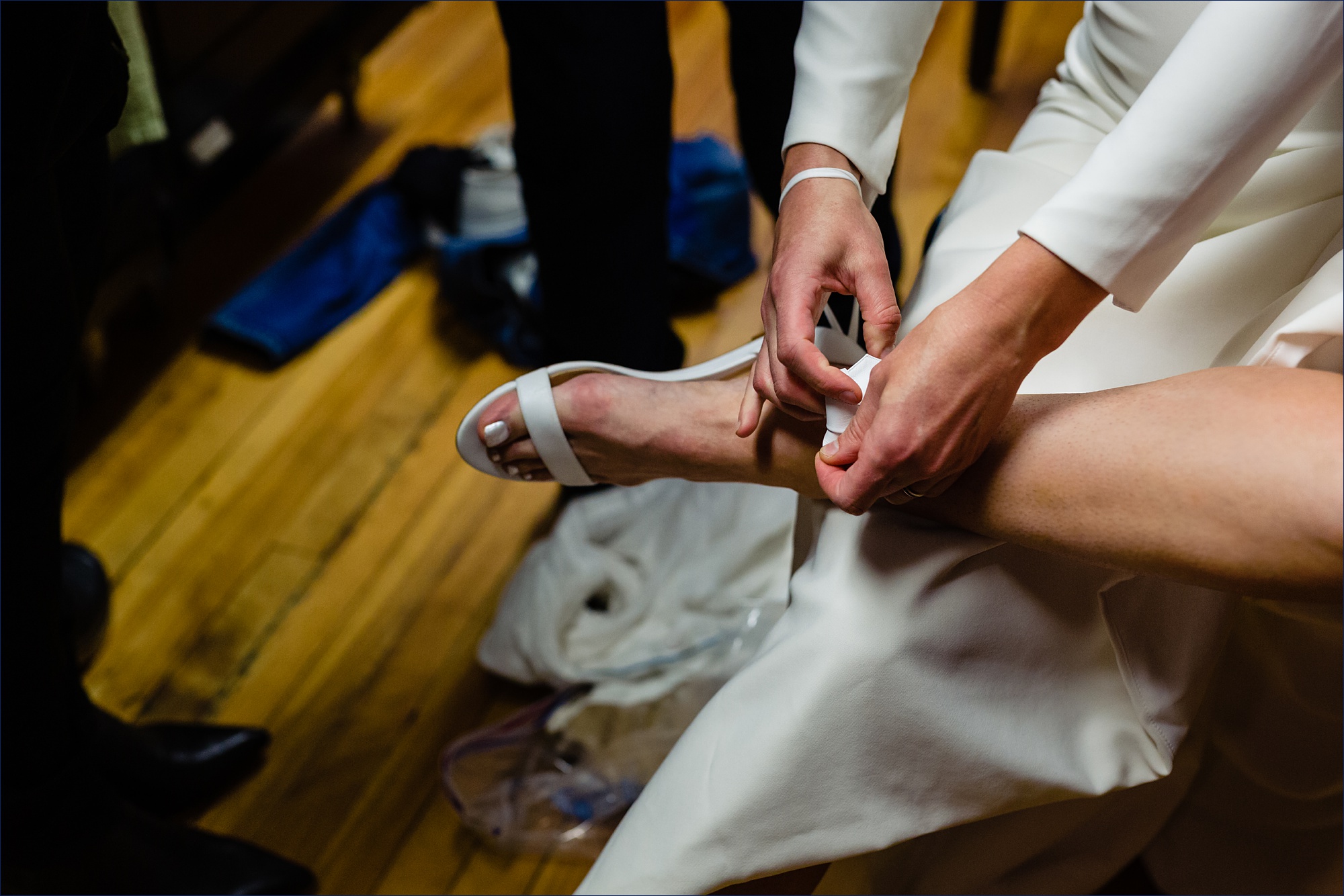 The bride gets into her wedding day shoes on her big day