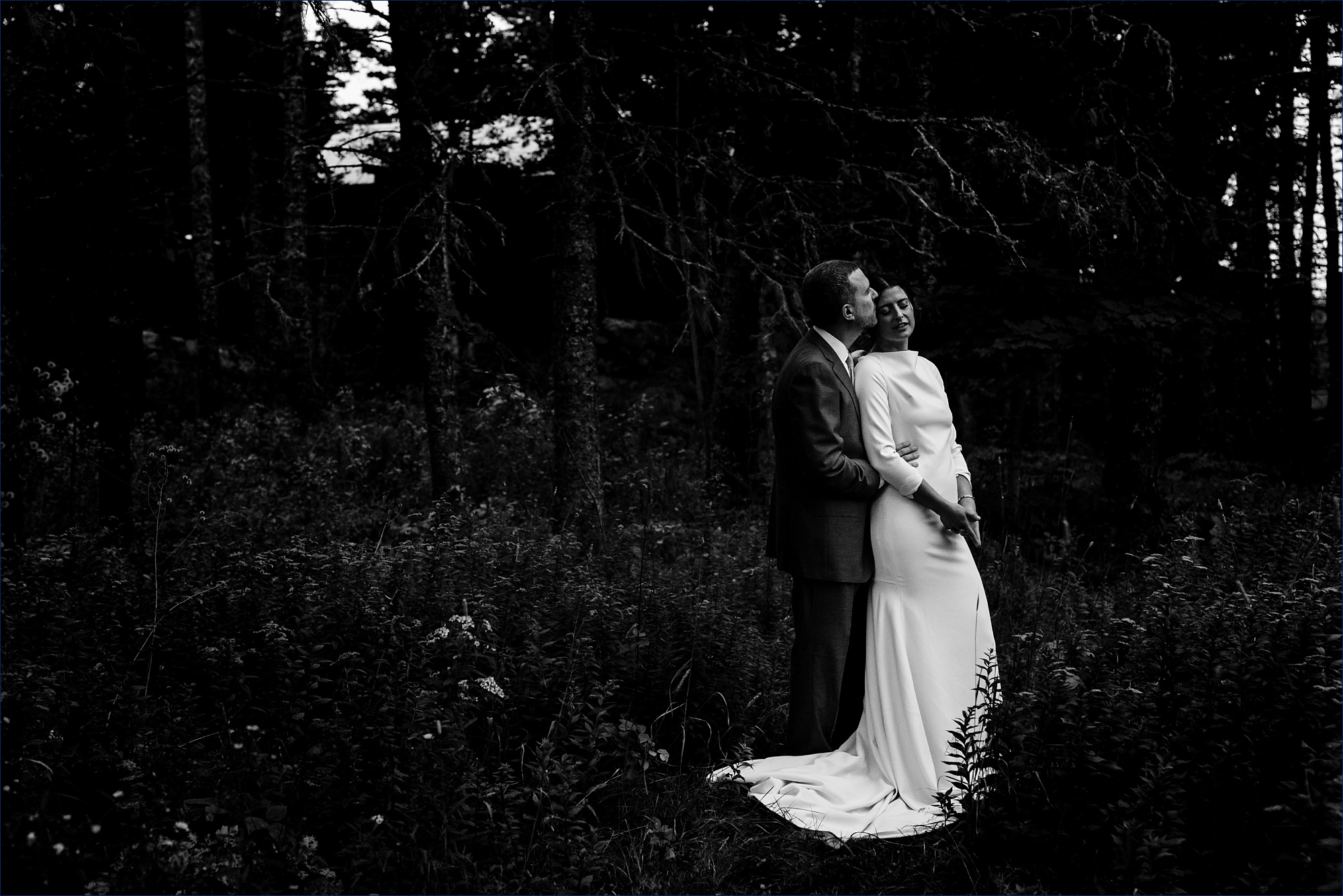 The bride and groom hold each other close before the rain starts on Little Cranberry Island for their wedding 
