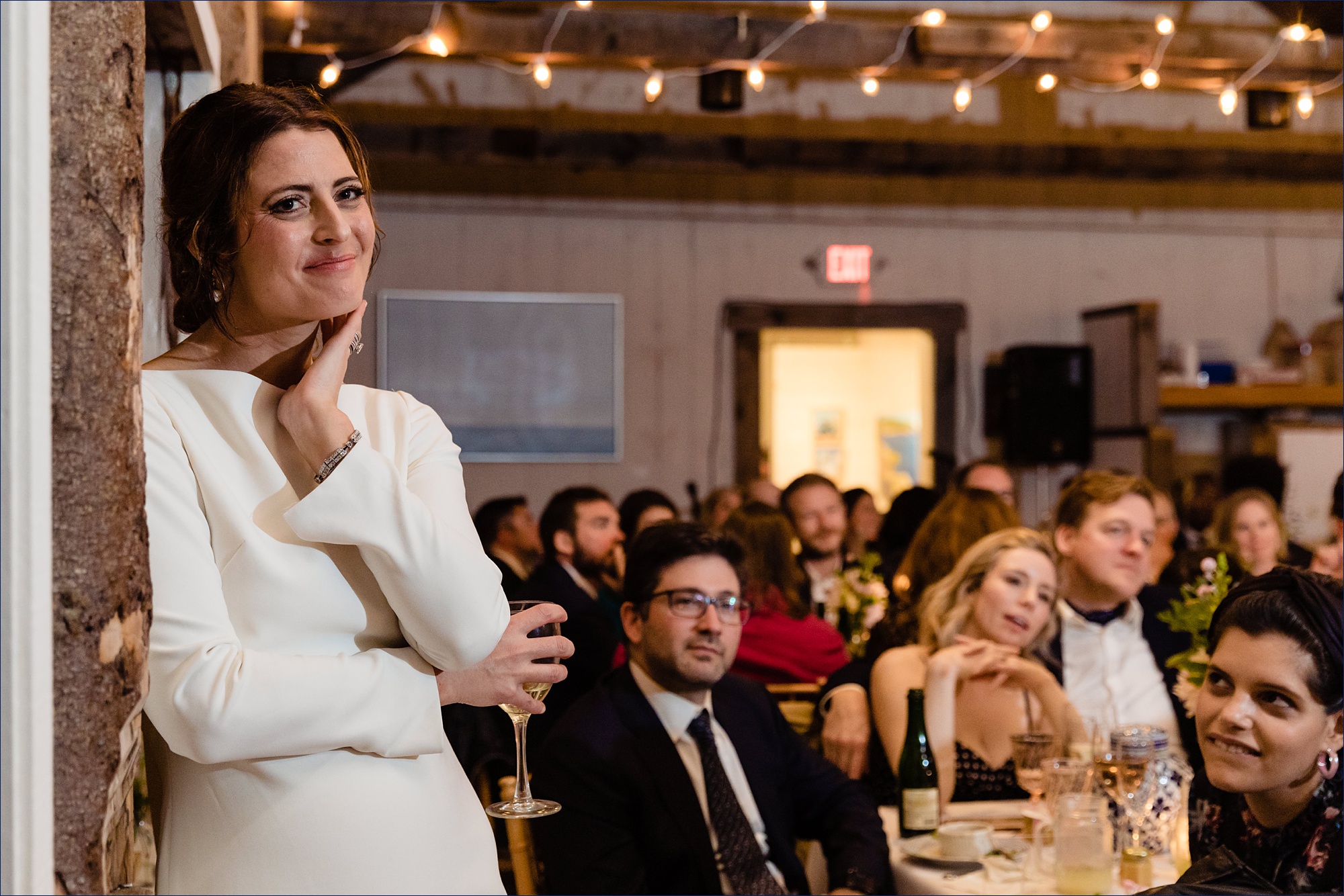 The bride can't contain her emotions listening to the toasts on her Maine wedding day