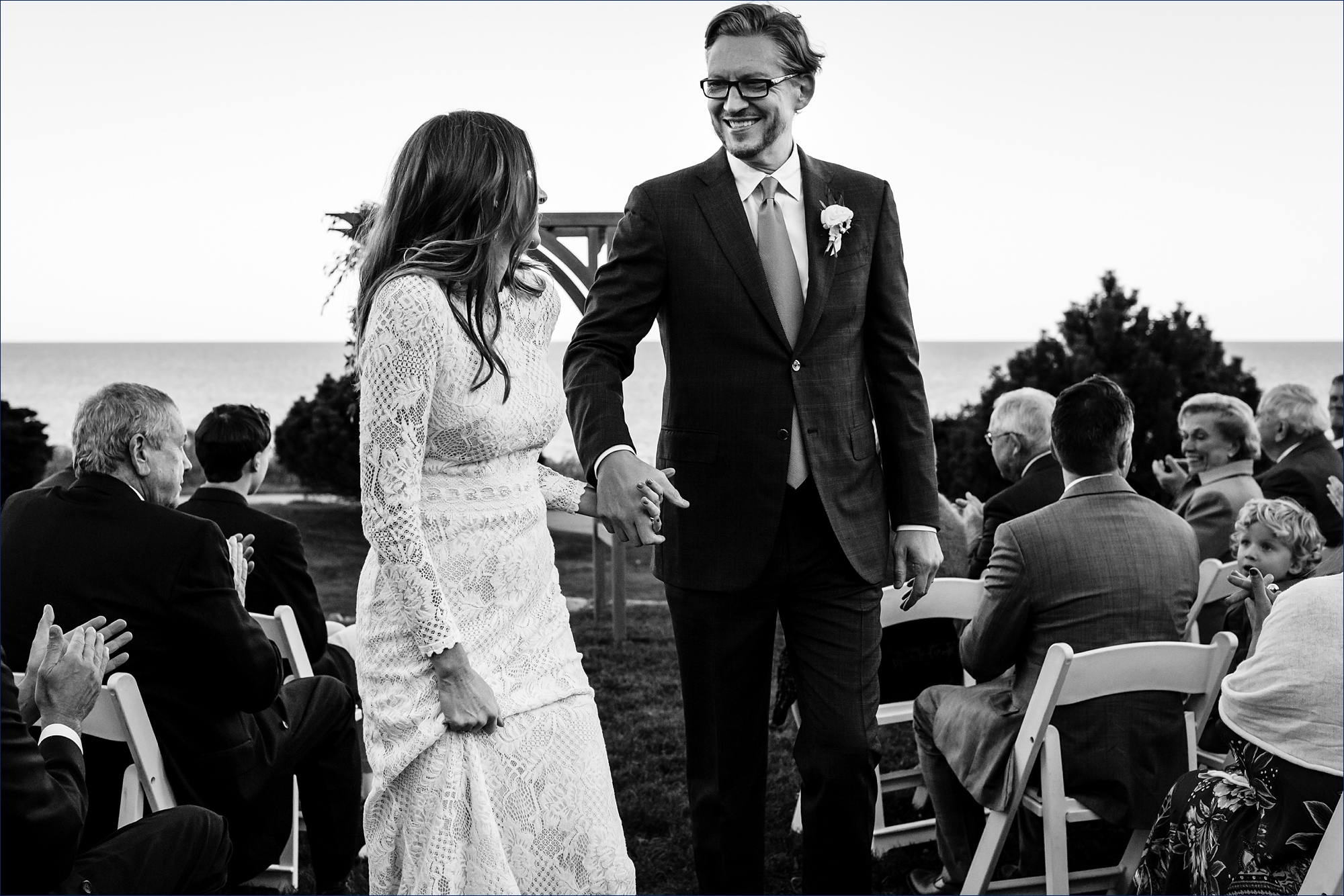 The newlyweds return back up the aisle after the intimate wedding celebration in Maine