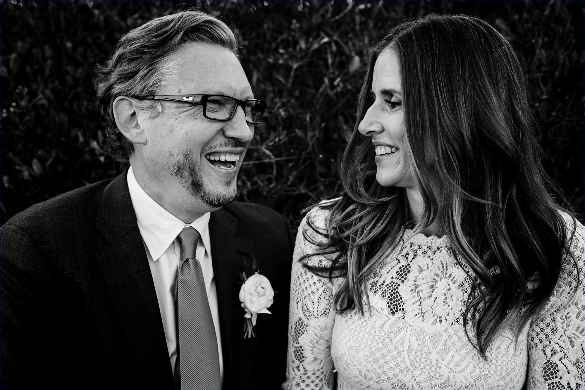 Husband and wife share a laugh after their Maine Wedding Day