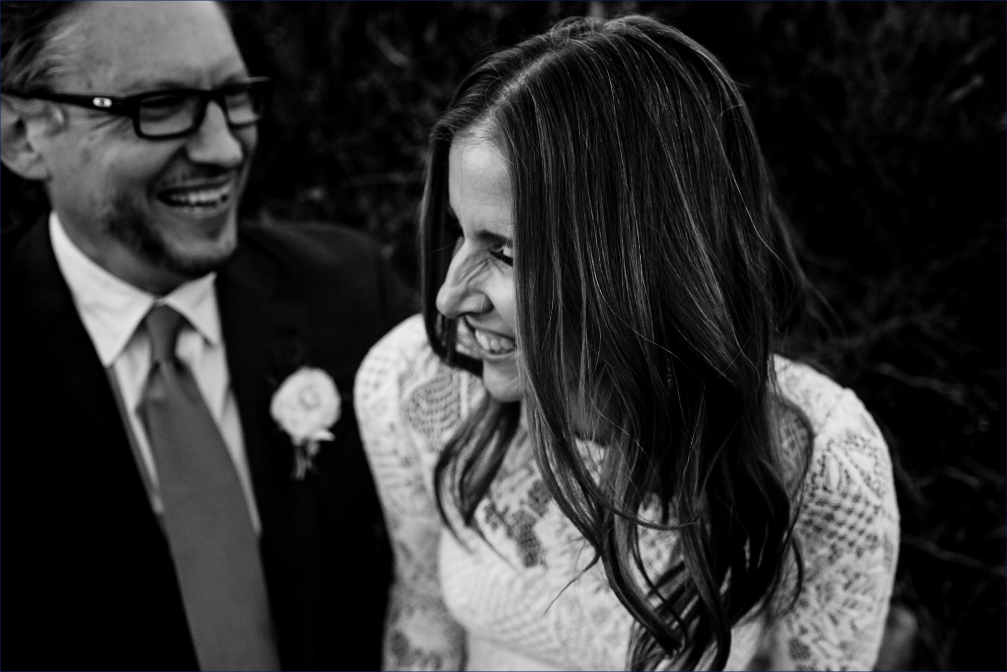 Husband and wife share a laugh after their Maine Wedding Day
