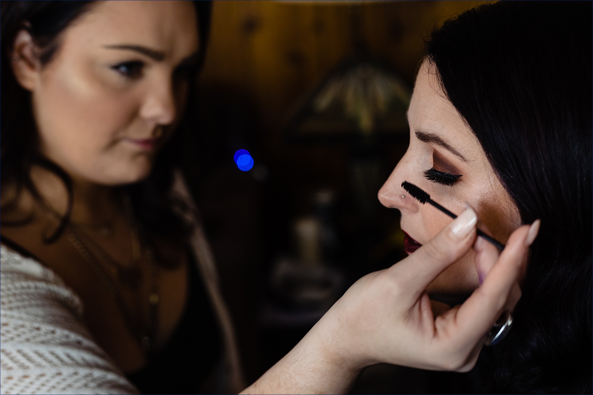 The bride gets ready in her home in New Hampshire with the makeup artist