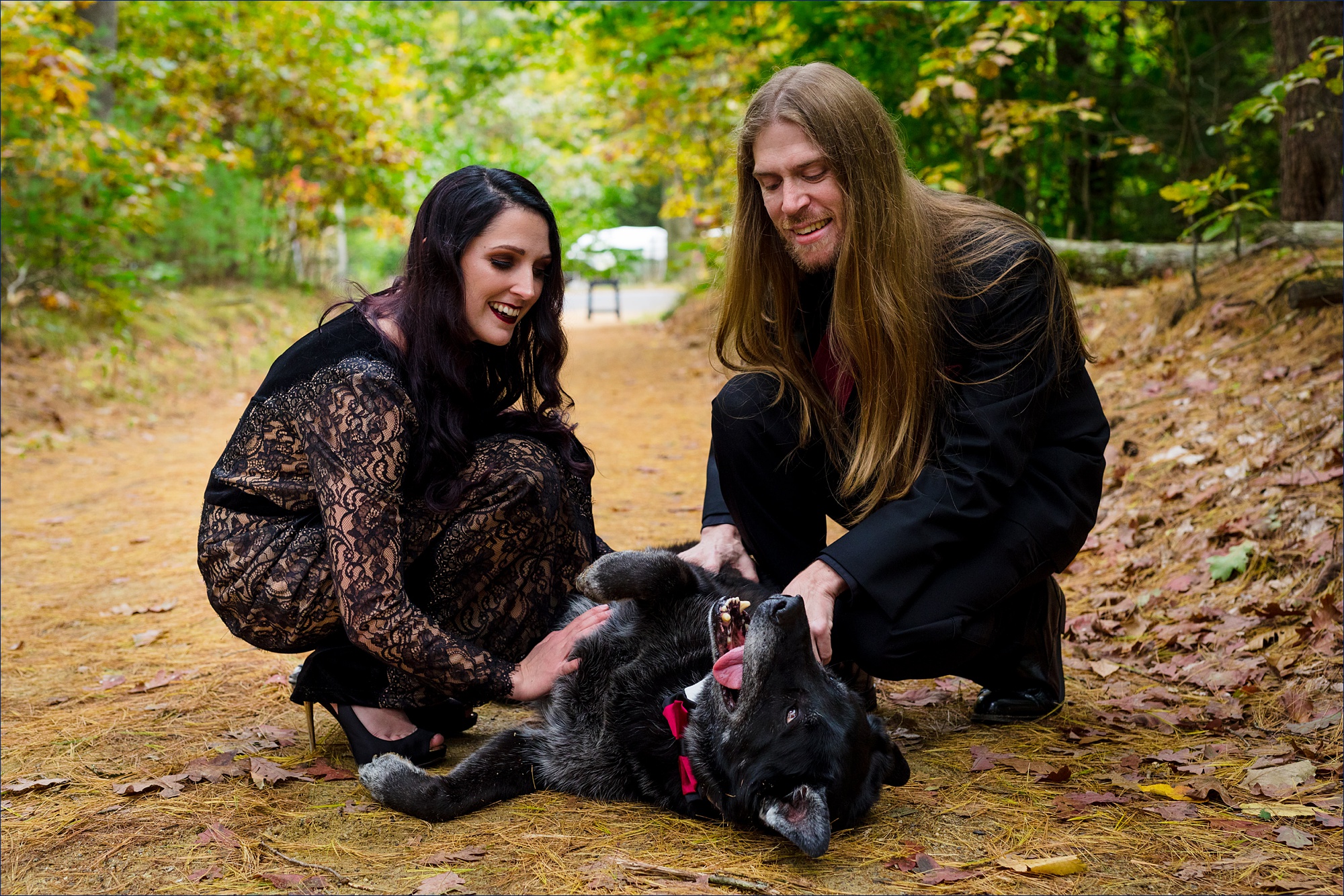 The bride and groom with their dog enjoy the wedding day fun
