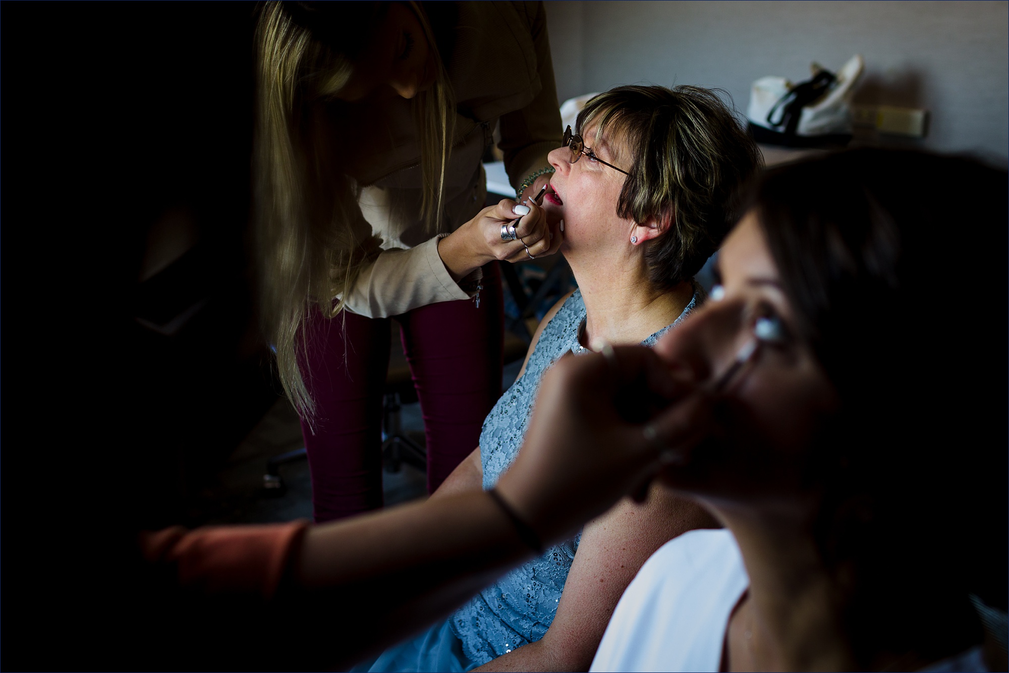 Both the mom and the bride sit to have their makeup done for the Portsmouth NH wedding day