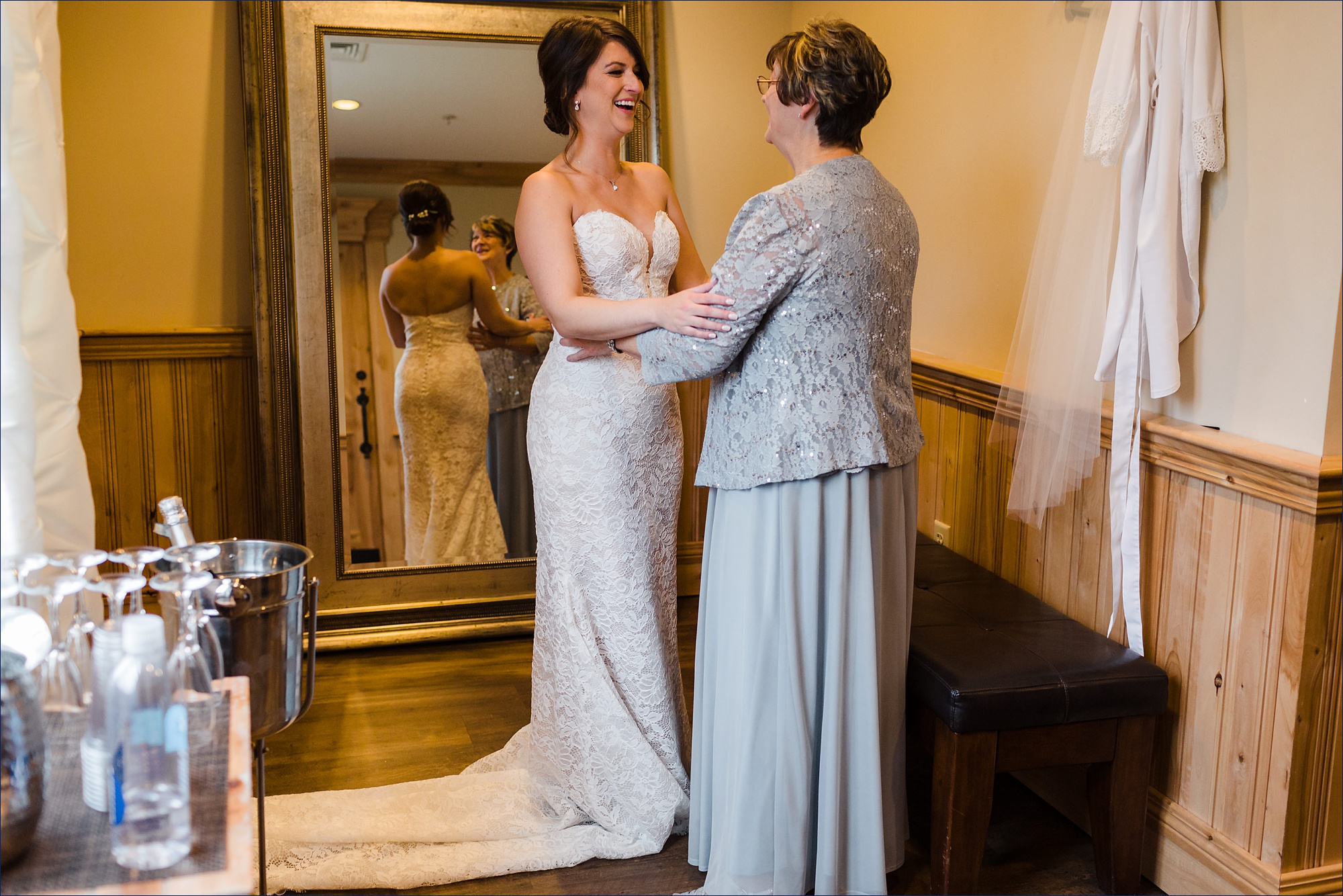 The bride and her mom hold one another before the wedding day starts in Maine