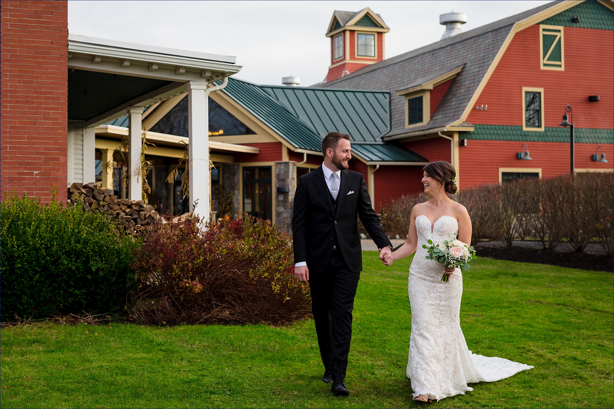 The couple walks together on the grounds of the Red Barn at Outlook Farm in Maine