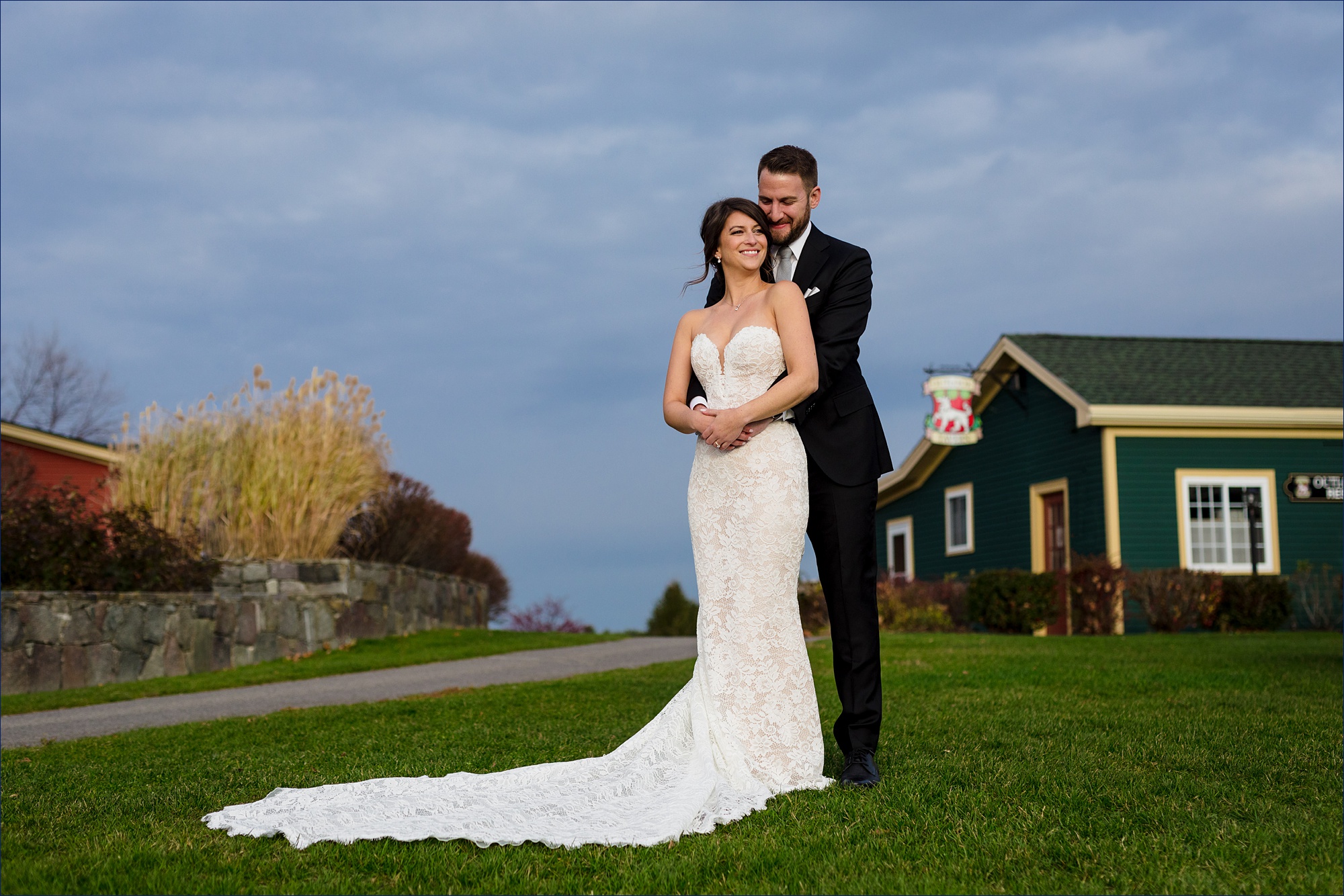 Holding onto one another tight as the storm clouds brew behind them on their Maine wedding day