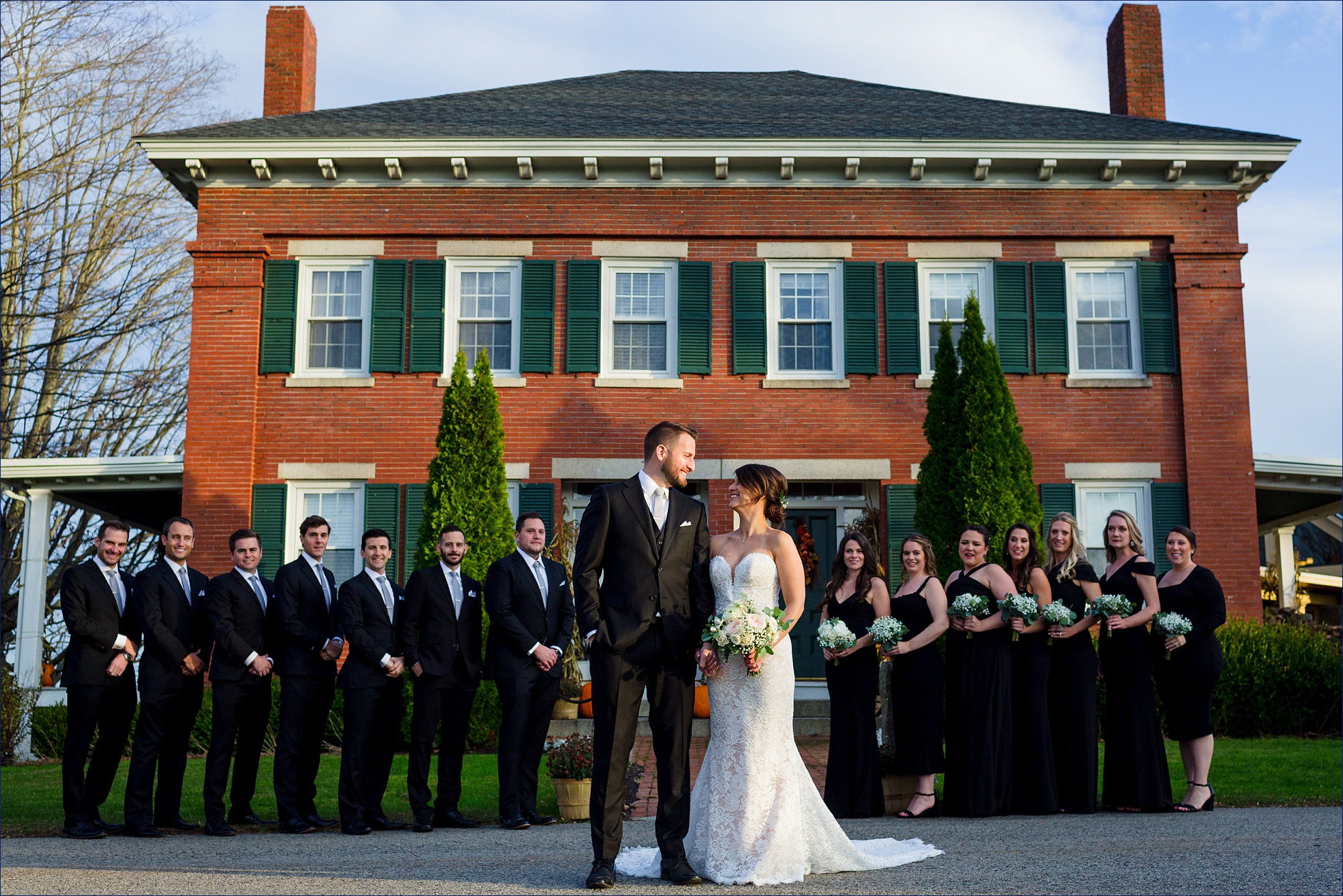 The wedding party stands together at The Red Barn at Outlook Farm in Maine