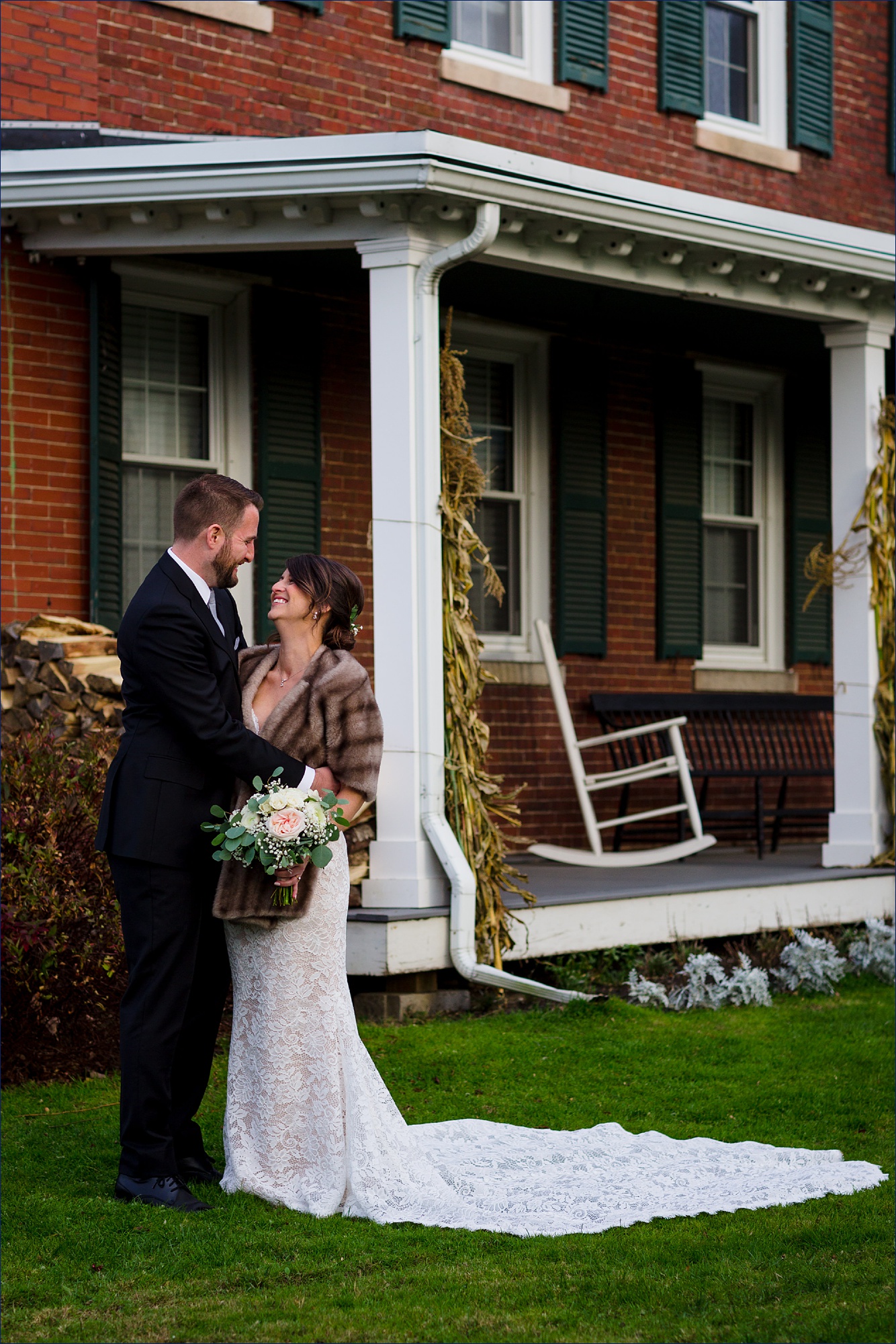 The couple stand together on their fall wedding day at The Red Barn at Outlook Farm