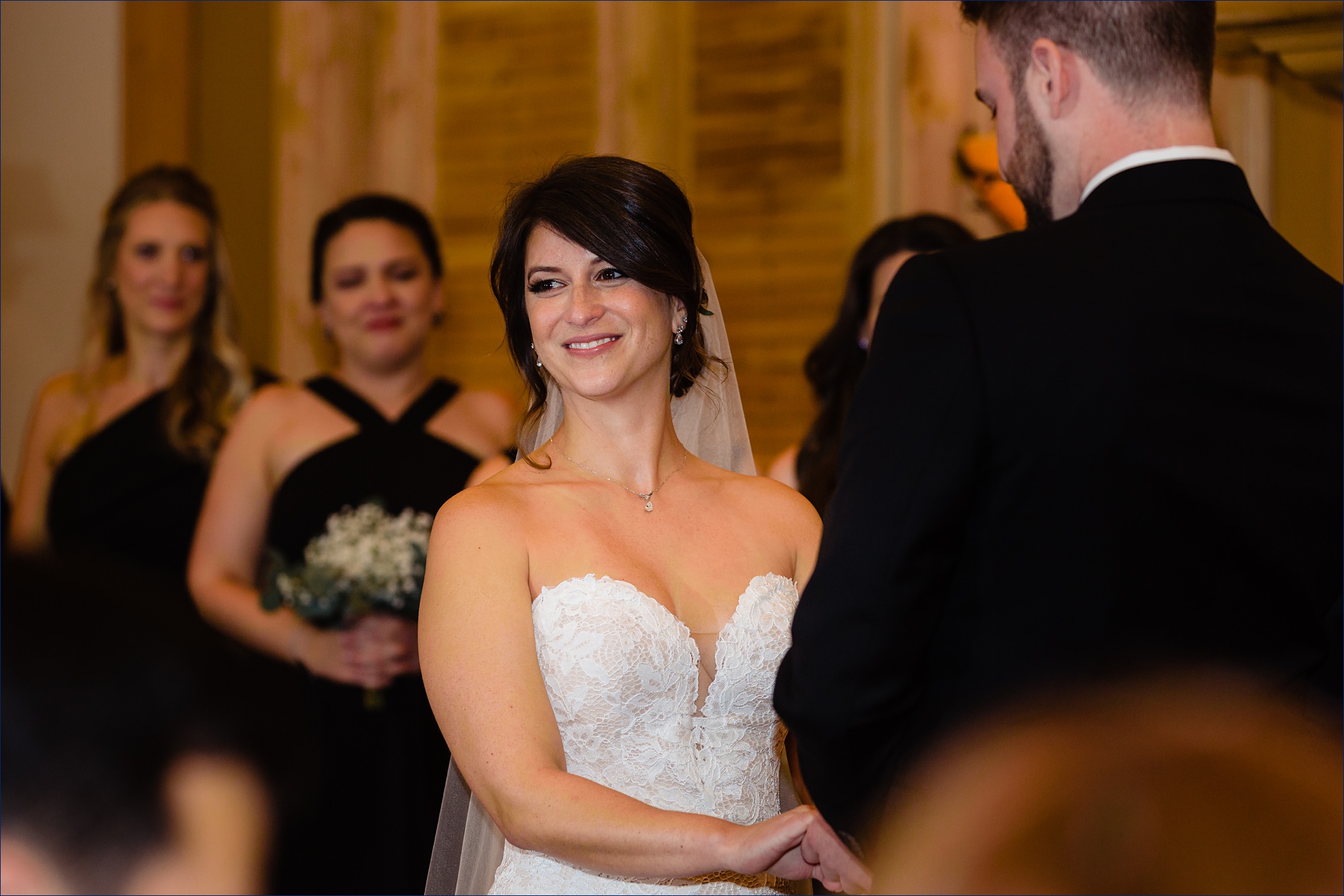 The bride smiles at her family as the wedding ceremony takes place